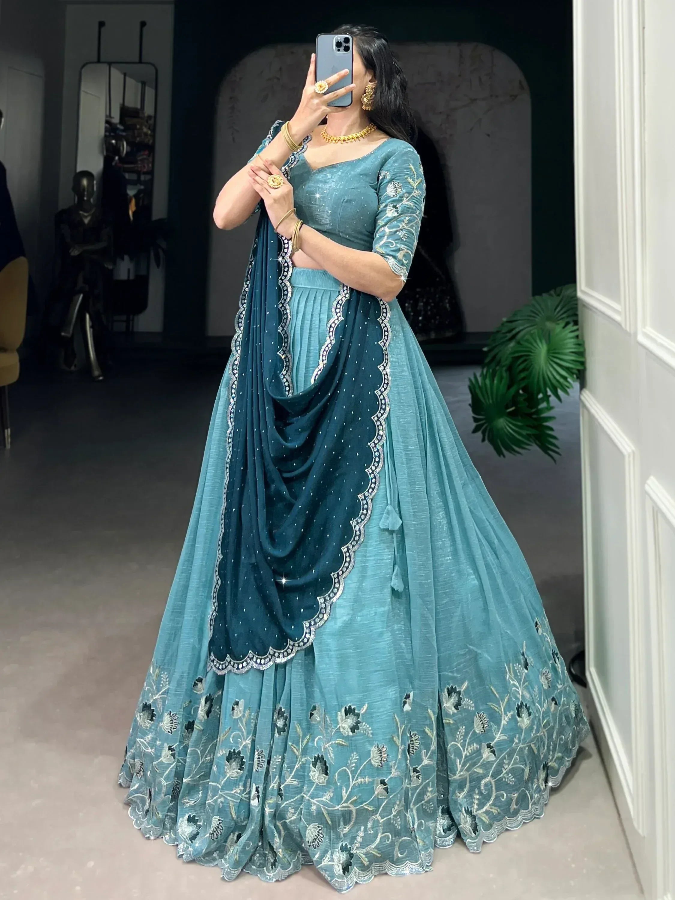 Teal embroidered lehenga choli with floral detailing and scalloped dupatta, perfect for Indian ethnic wear occasions.