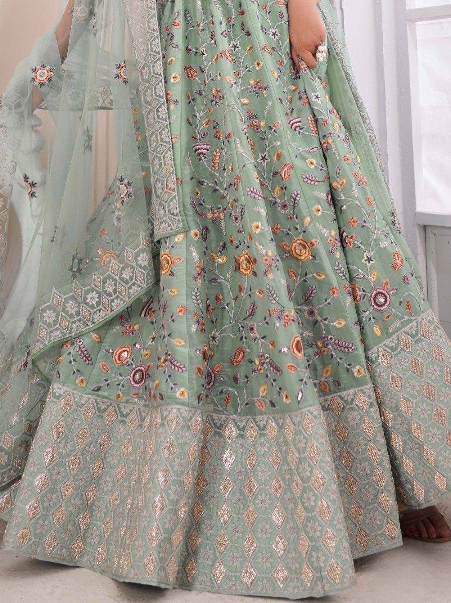 Mint green embroidered lehenga choli with floral and geometric patterns, perfect for Indian ethnic wear.