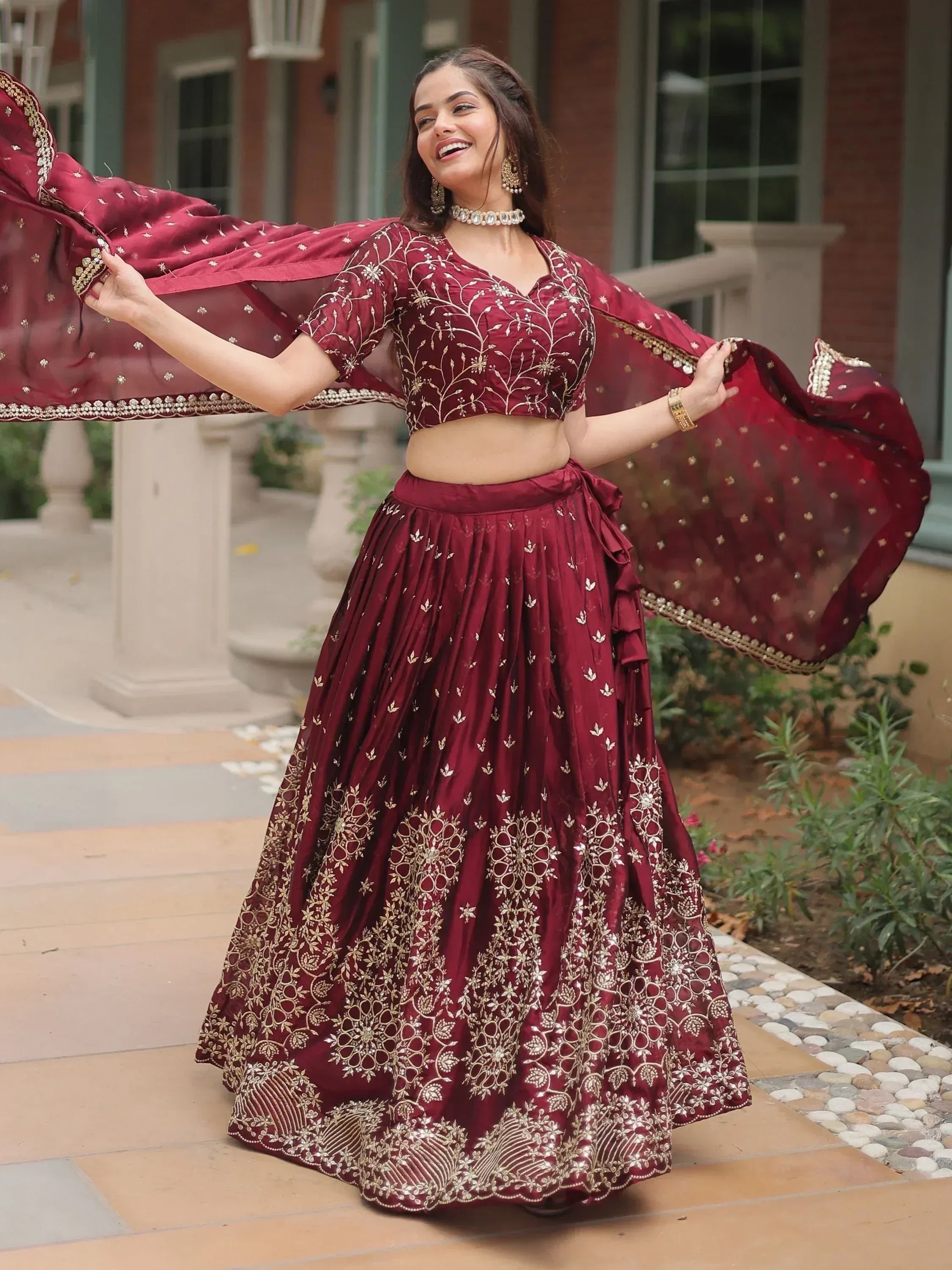 Woman in maroon embroidered lehenga choli with dupatta, Indian ethnic wear for weddings and festivals