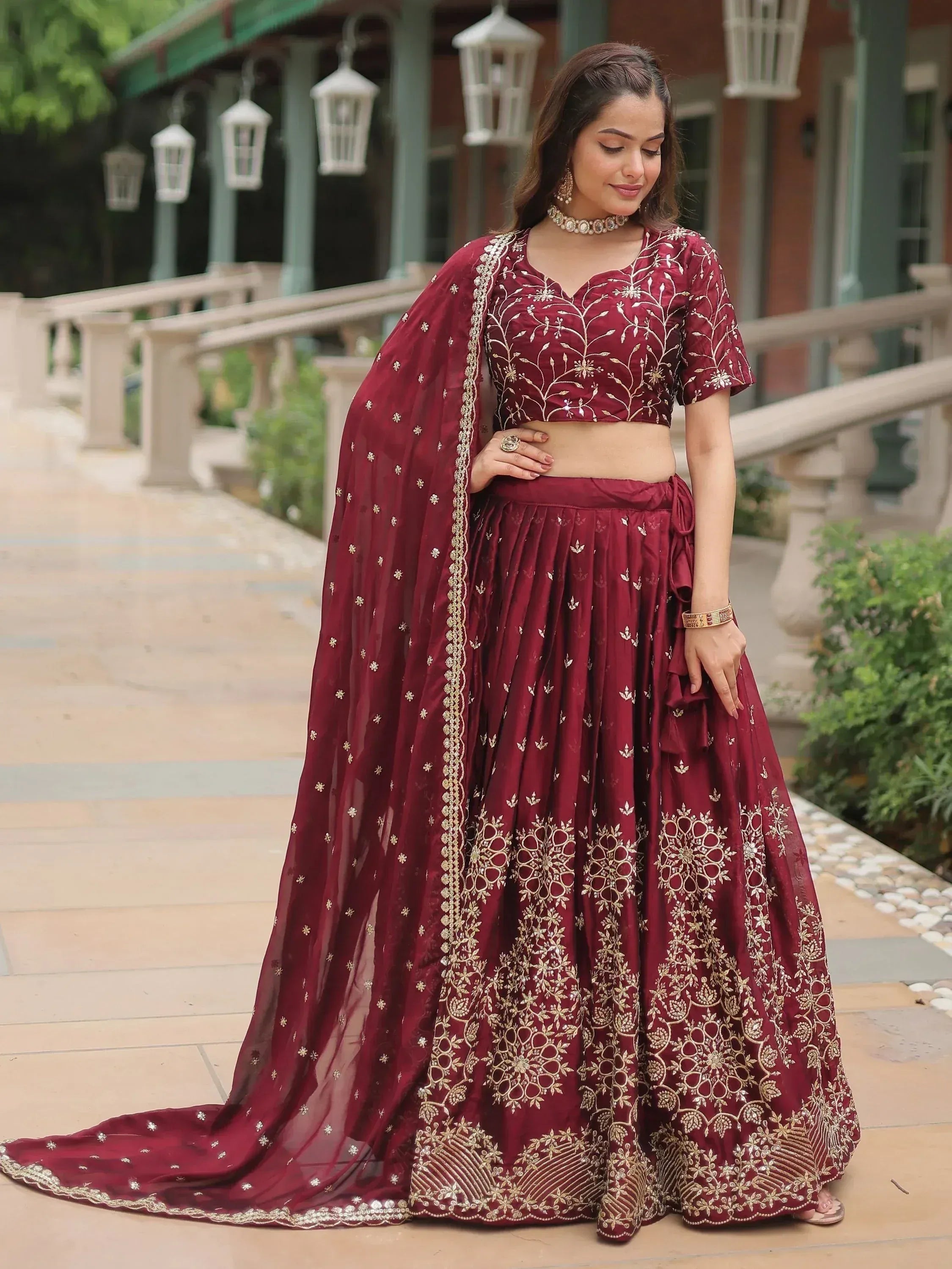Maroon embroidered lehenga choli with gold detailing, perfect for Indian ethnic wear and festive occasions
