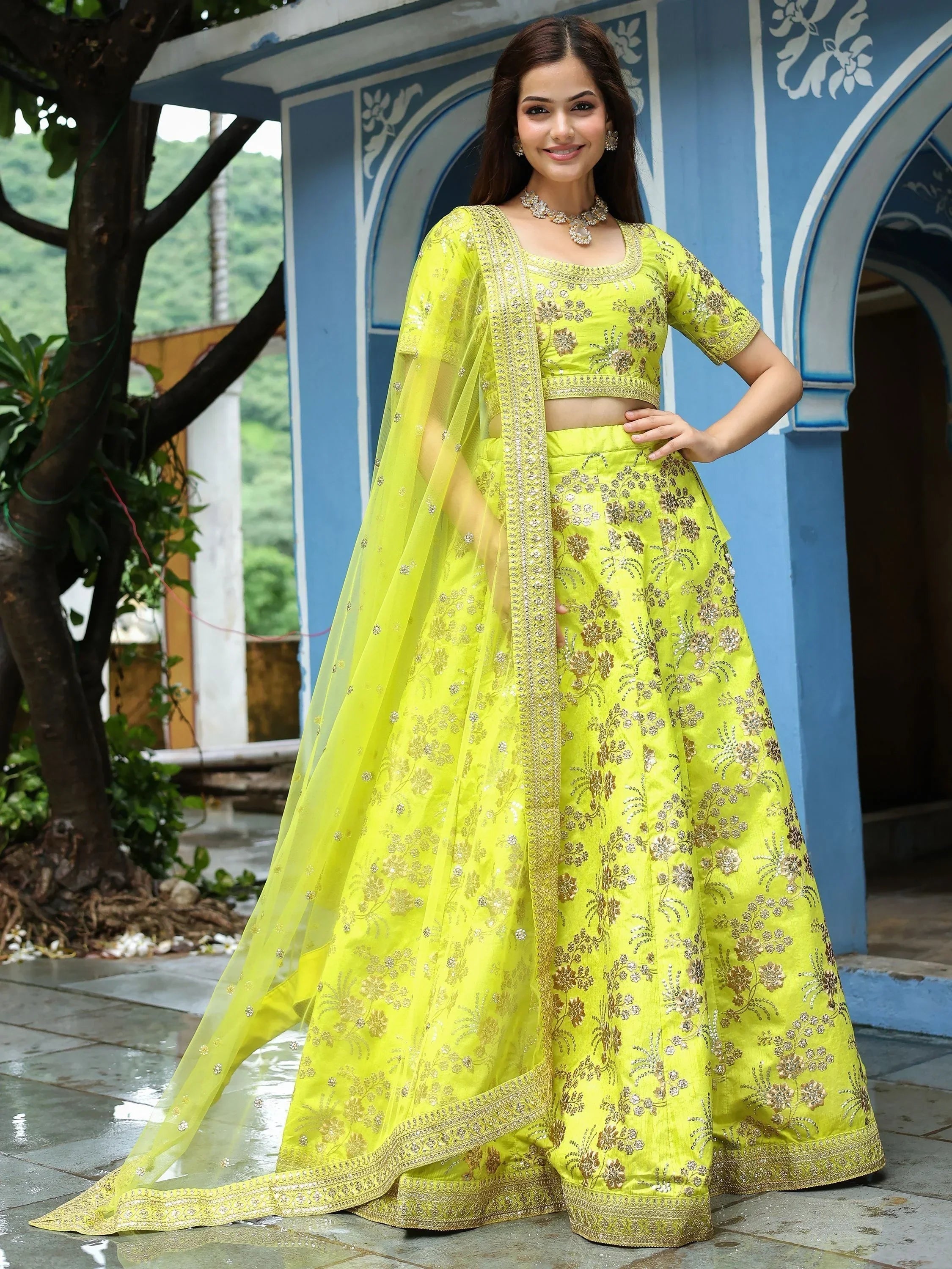 Bright yellow embroidered lehenga choli with floral motifs, perfect for Indian ethnic wear events.
