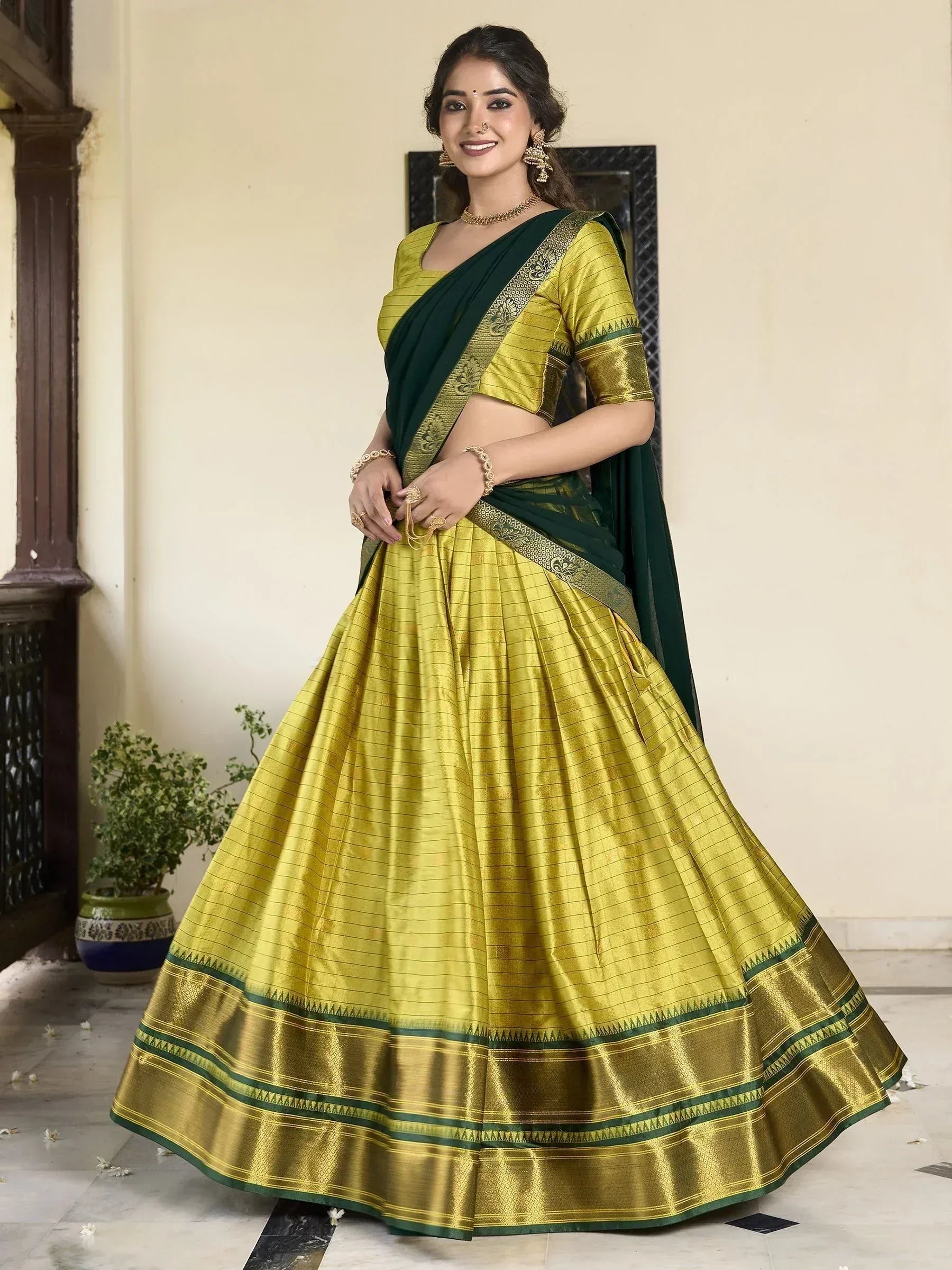 Yellow and green designer lehenga choli with embroidered border, perfect for Indian ethnic wear occasions