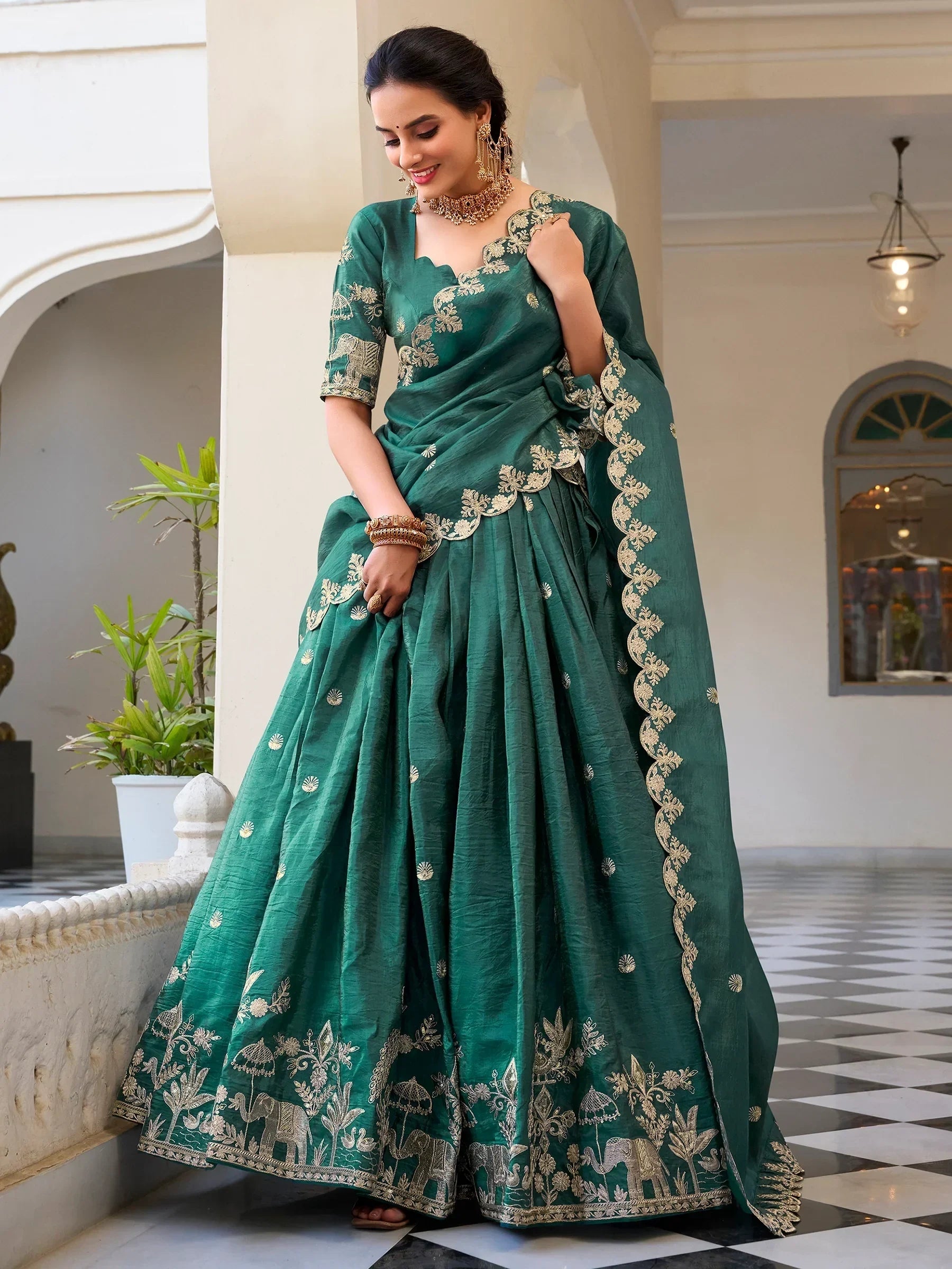 Emerald green lehenga choli with gold elephant embroidery, perfect for Indian ethnic wear occasions.