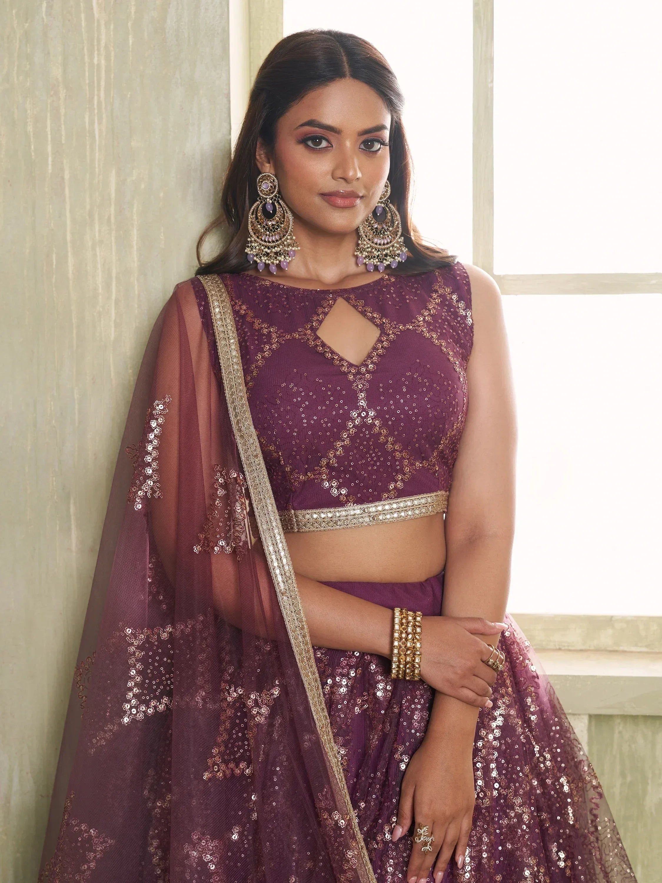 Purple sequined lehenga choli with gold embroidery, perfect for Indian weddings and festive occasions.