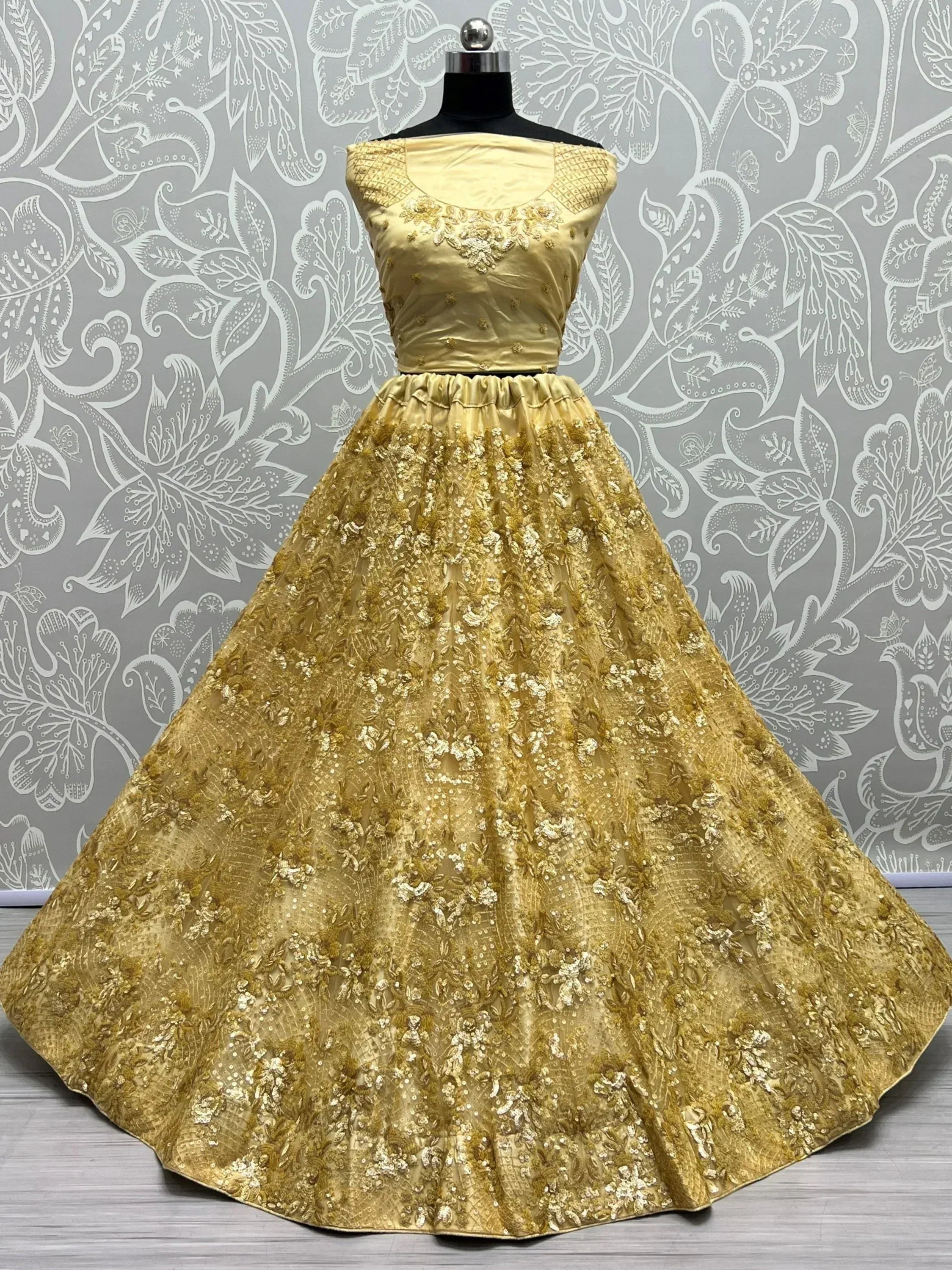 Golden embroidered ethnic gown with floral detailing, perfect for Indian weddings and festive occasions.