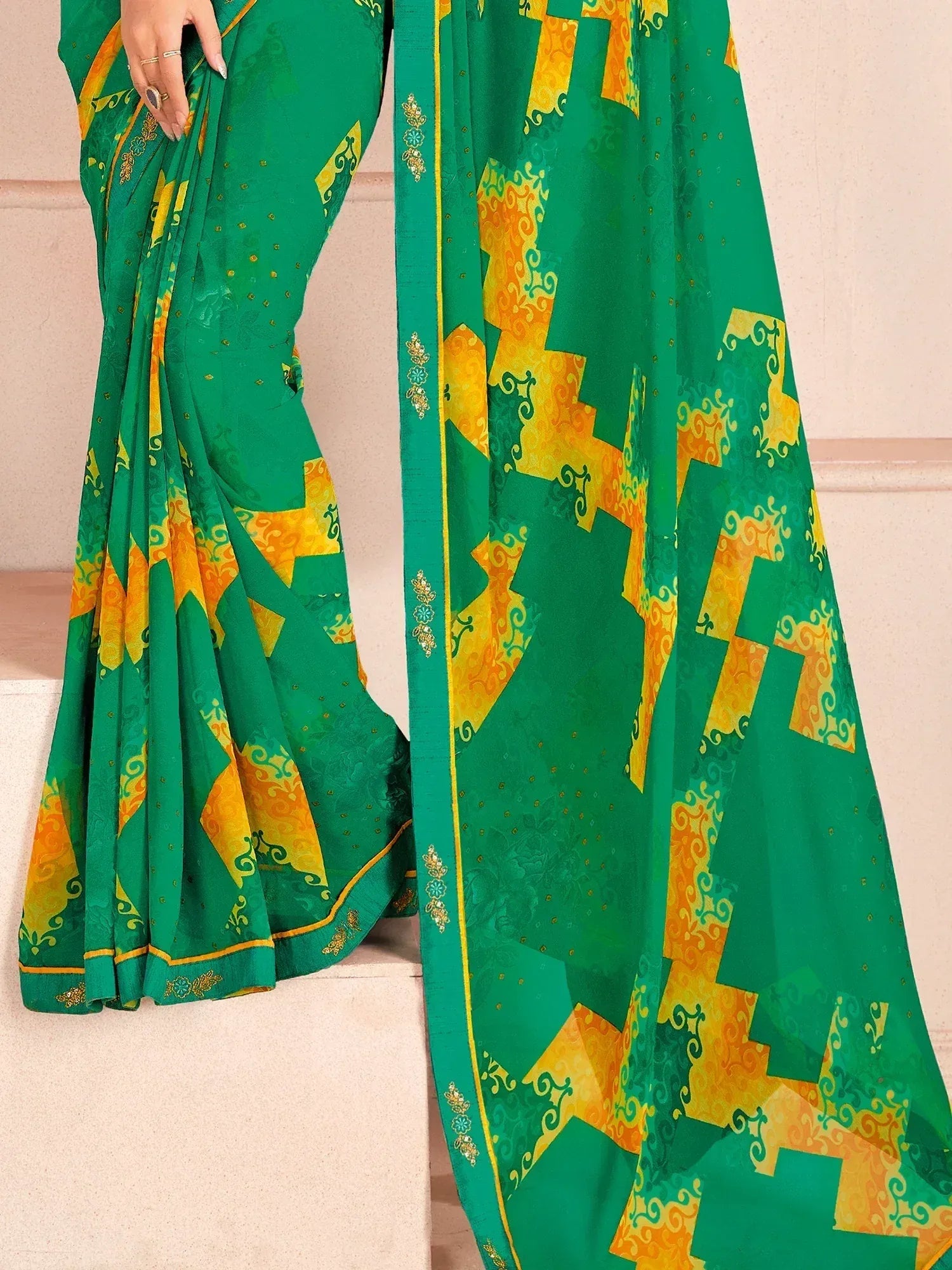 Green and yellow printed saree with geometric patterns and gold border, ideal for ethnic wear