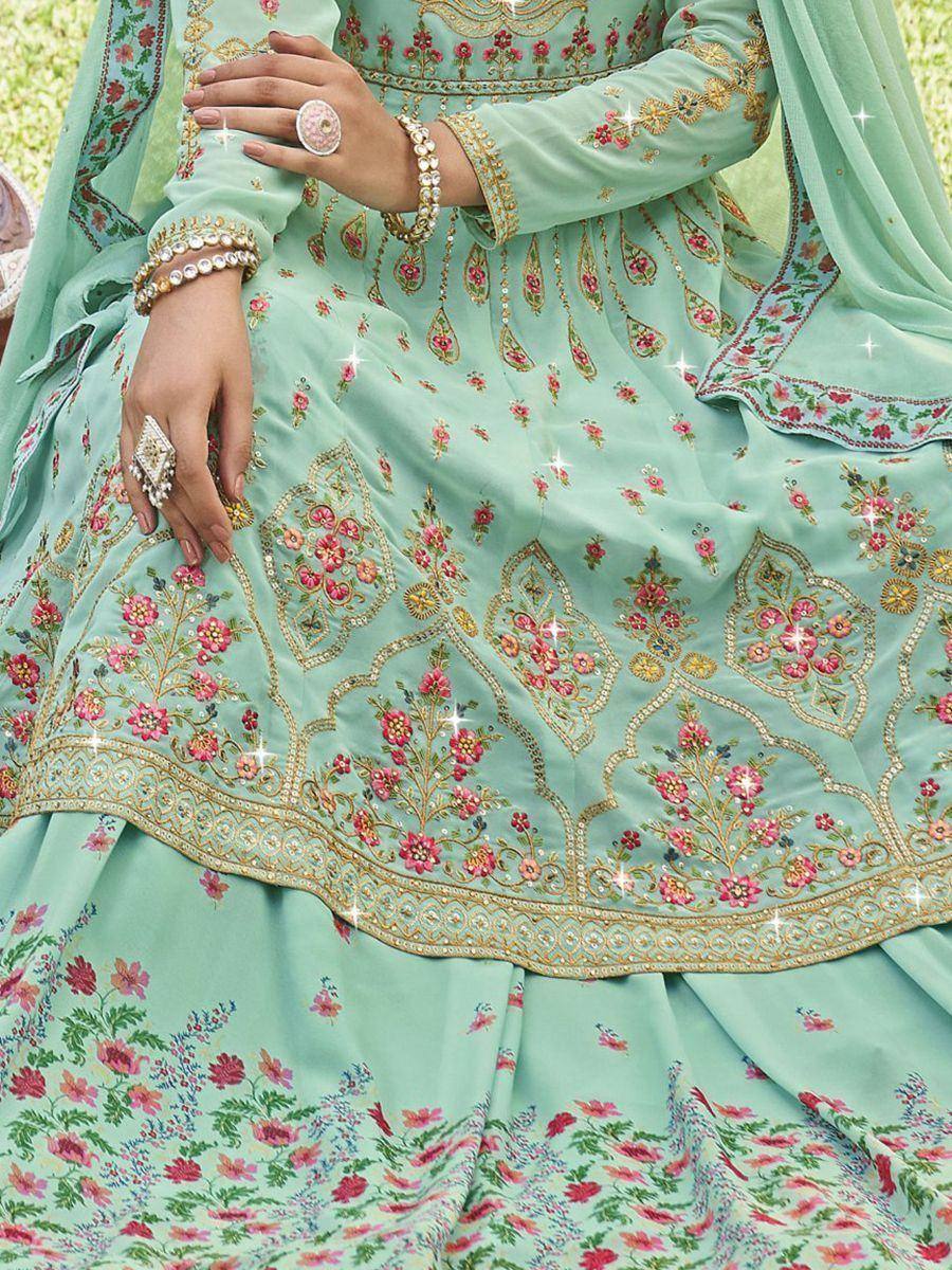 Mint green designer lehenga choli with floral embroidery and gold detailing, perfect for Indian ethnic wear