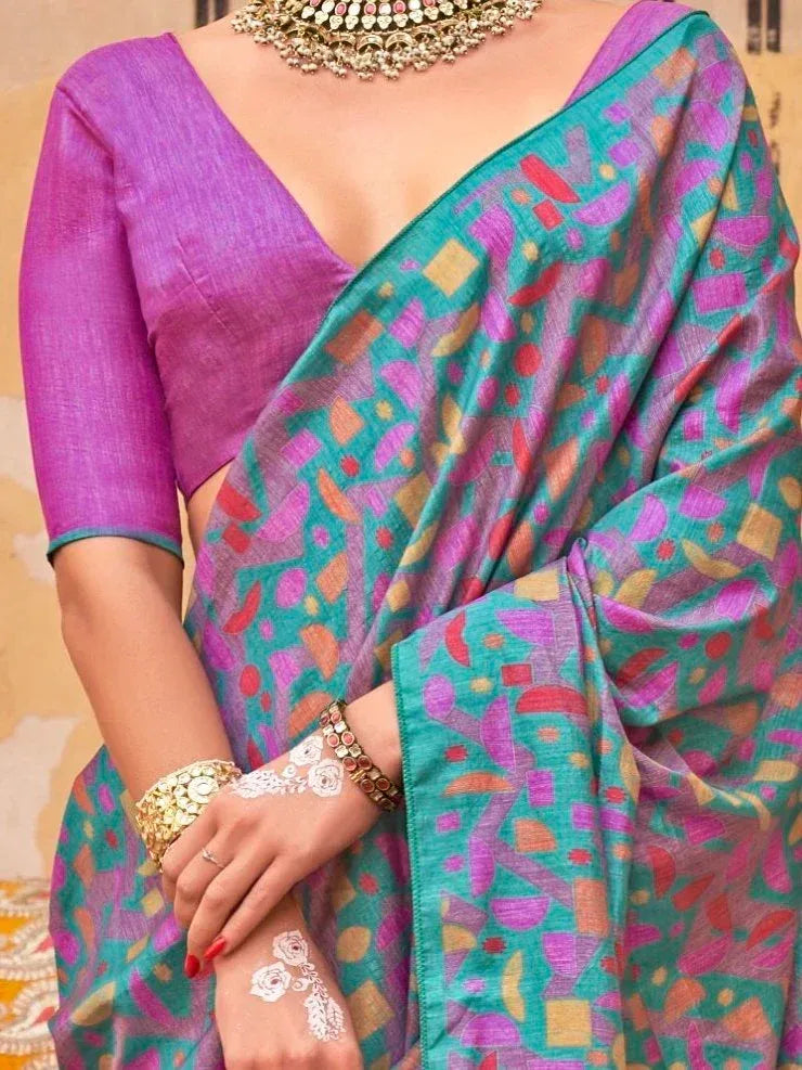 Vibrant teal and purple printed saree with geometric pattern, paired with matching blouse and traditional jewelry