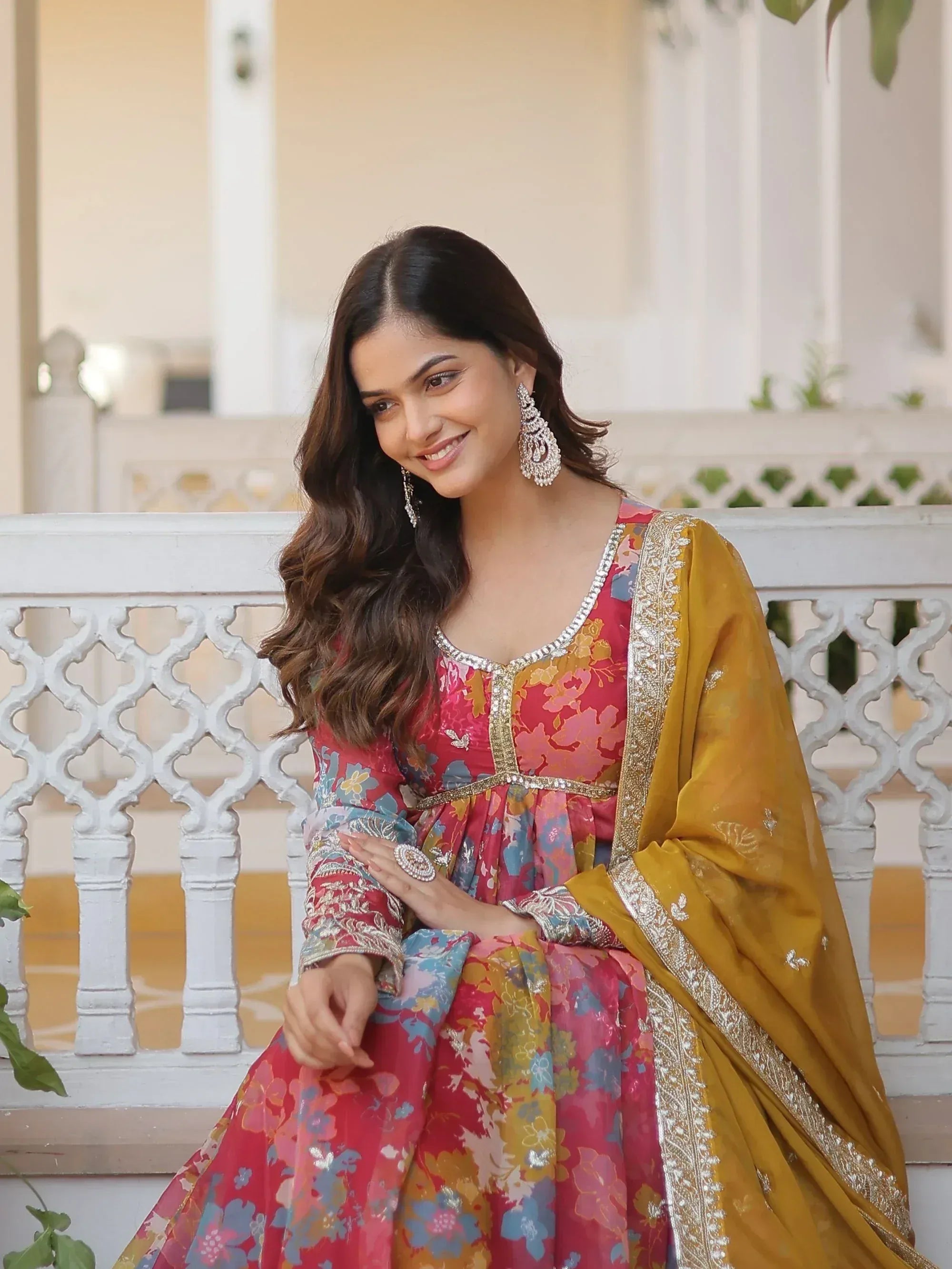 Woman in floral Indian anarkali with gold dupatta, perfect for ethnic occasions and festive wear.