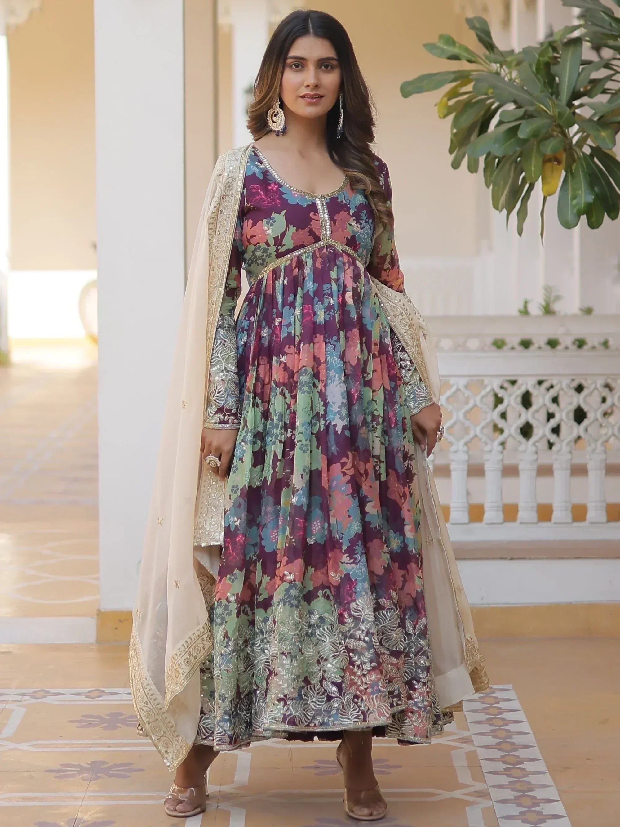 Red ethnic gown with gold trim, long sleeves, and polka dot print, perfect for Indian festive occasions.