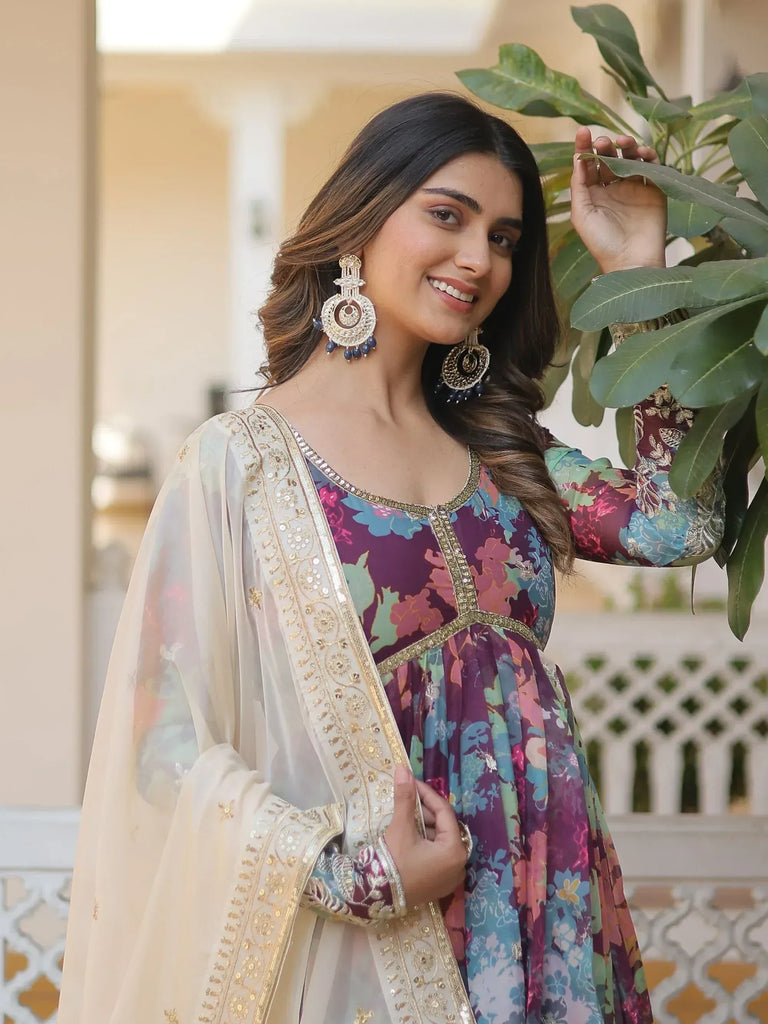 Woman in floral printed ethnic gown with embroidered dupatta and statement earrings
