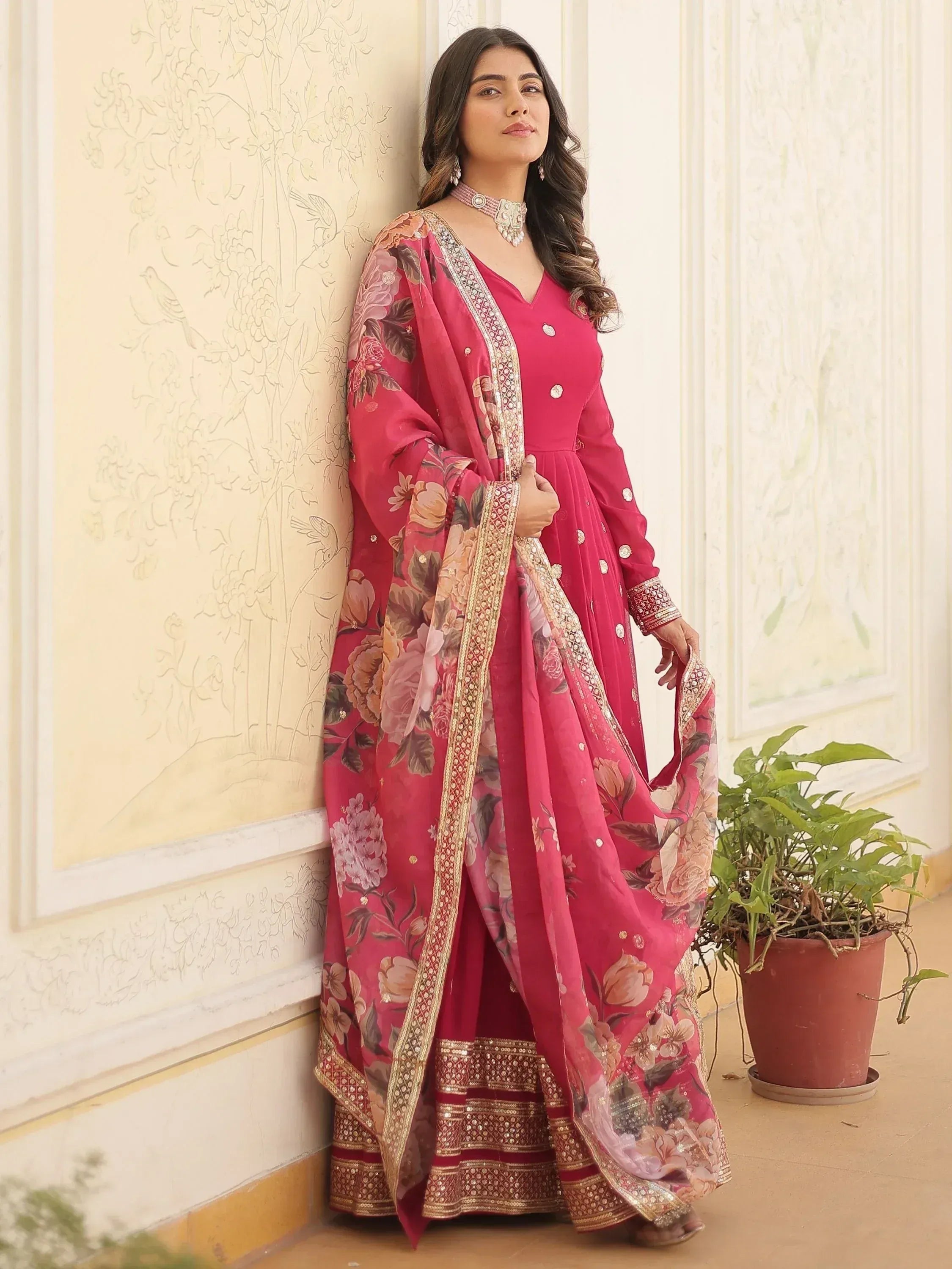 Pink floral print Indian ethnic salwar kameez with gold embroidery and dupatta, perfect for festive occasions.