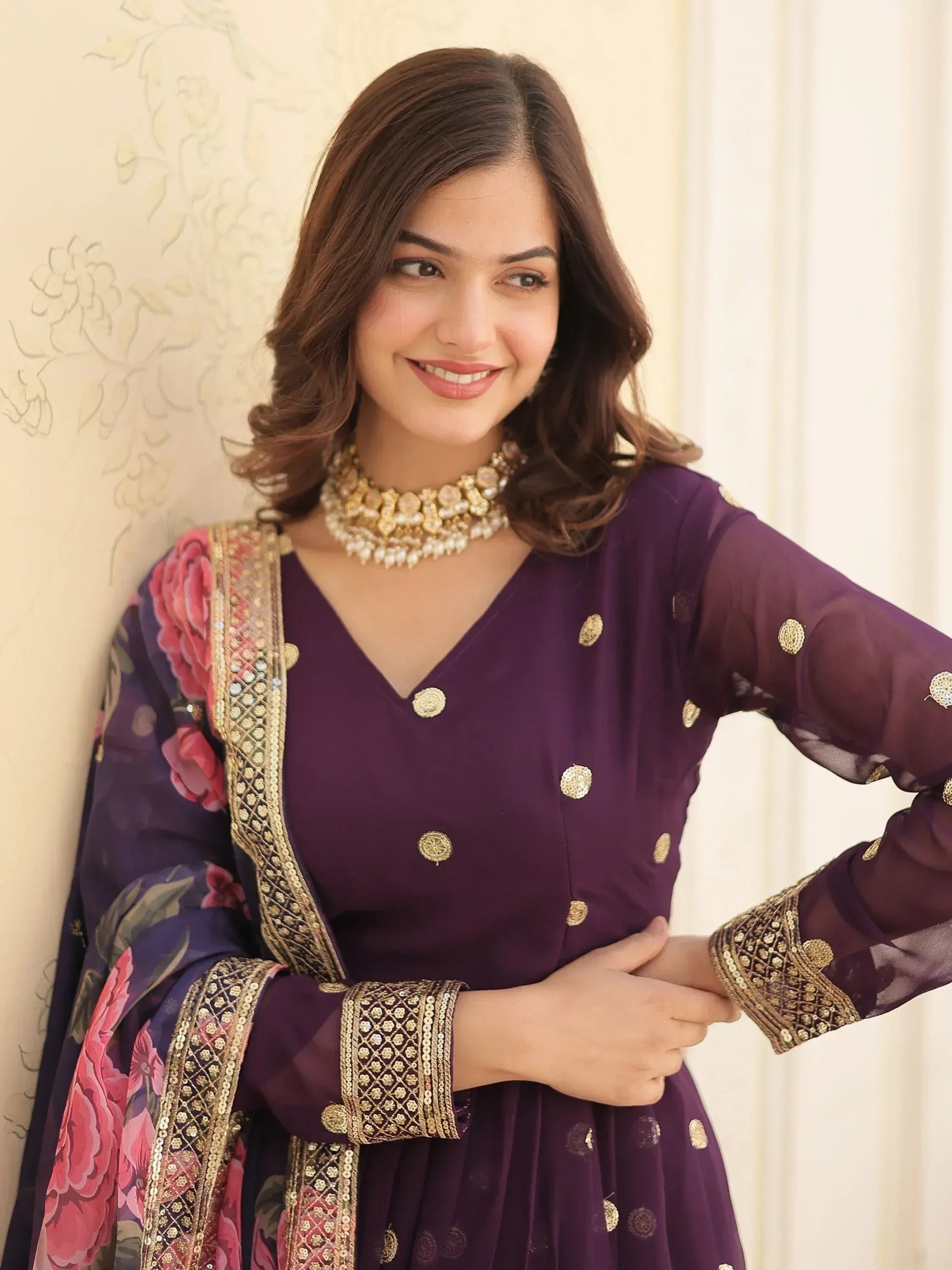 Purple ethnic gown with gold embroidery and floral dupatta, perfect for Indian occasions