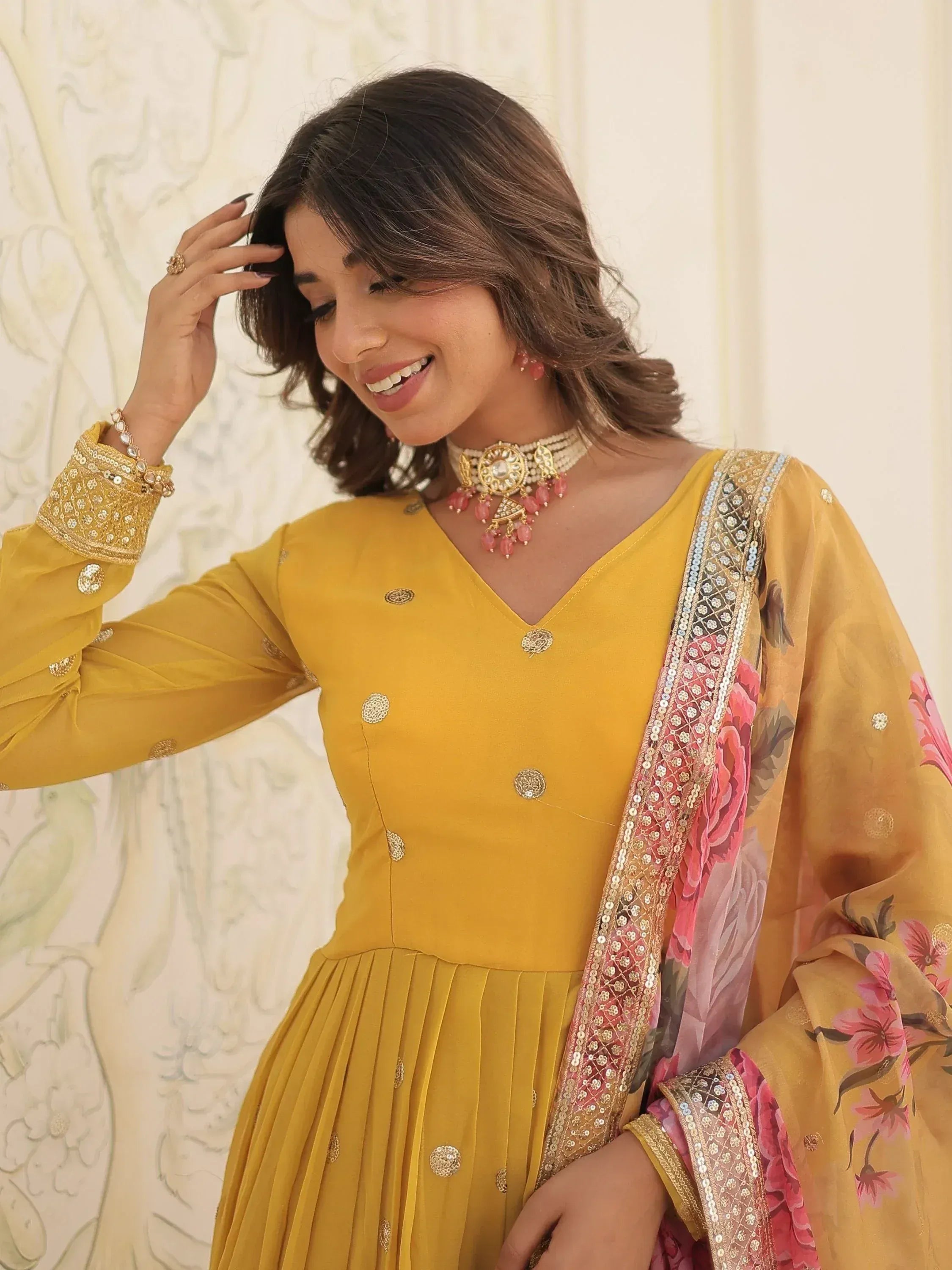 Yellow ethnic gown with floral dupatta and gold embroidery, perfect for Indian occasions