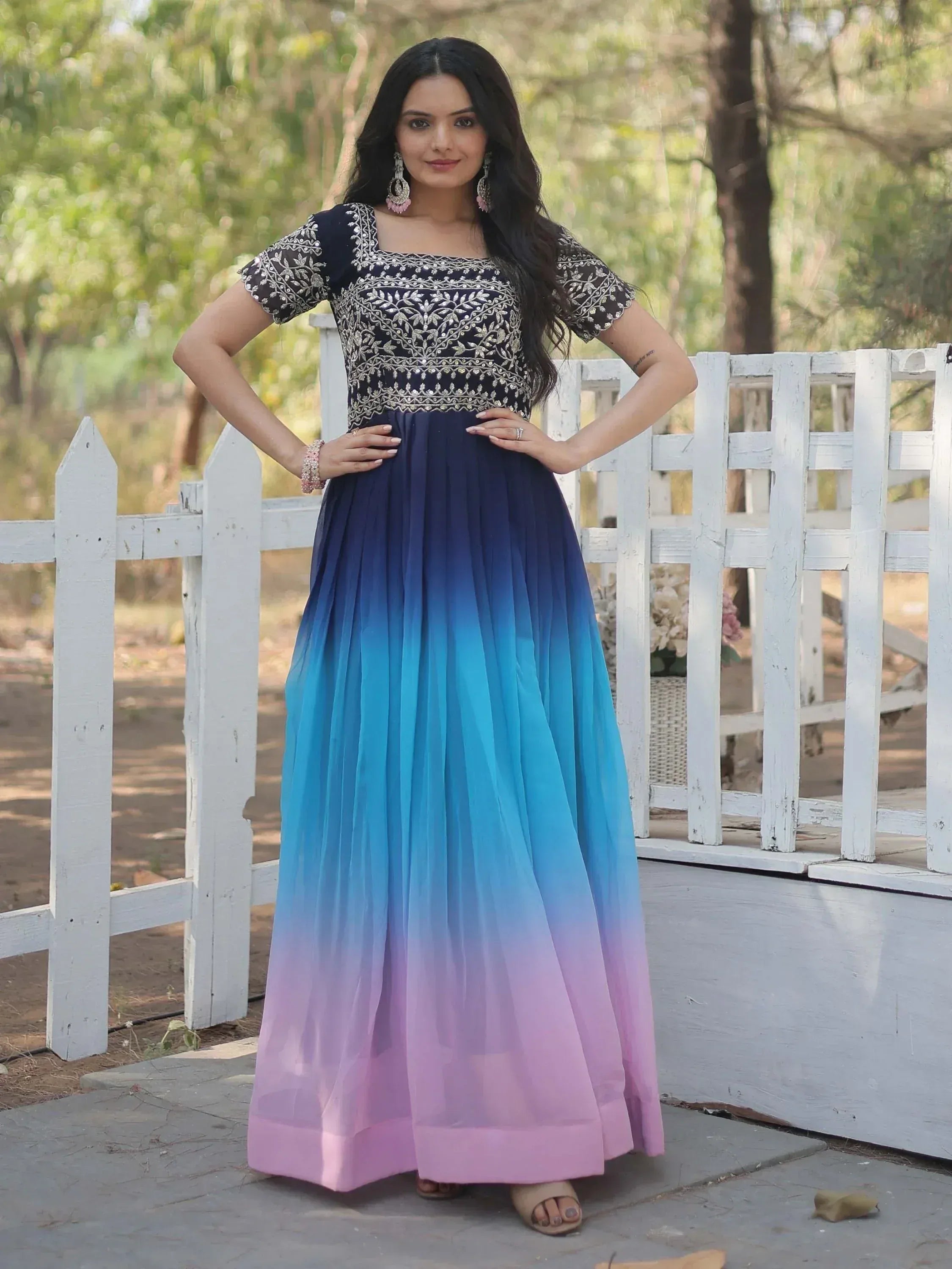 Woman in navy embroidered top with ombre blue to pink pleated skirt, Indian ethnic gown