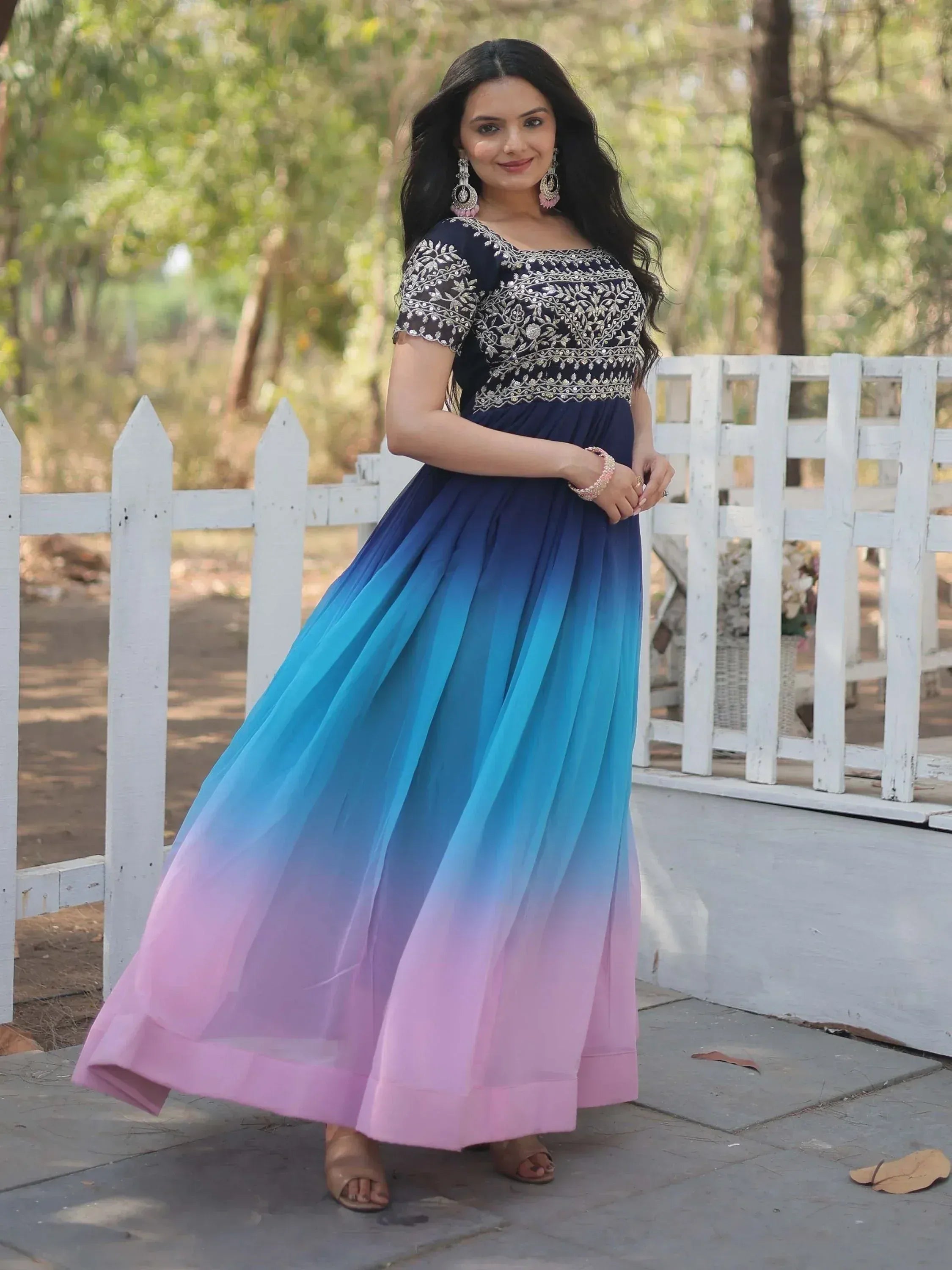 Woman in embroidered navy blue to pink ombre ethnic gown, perfect for Indian occasions