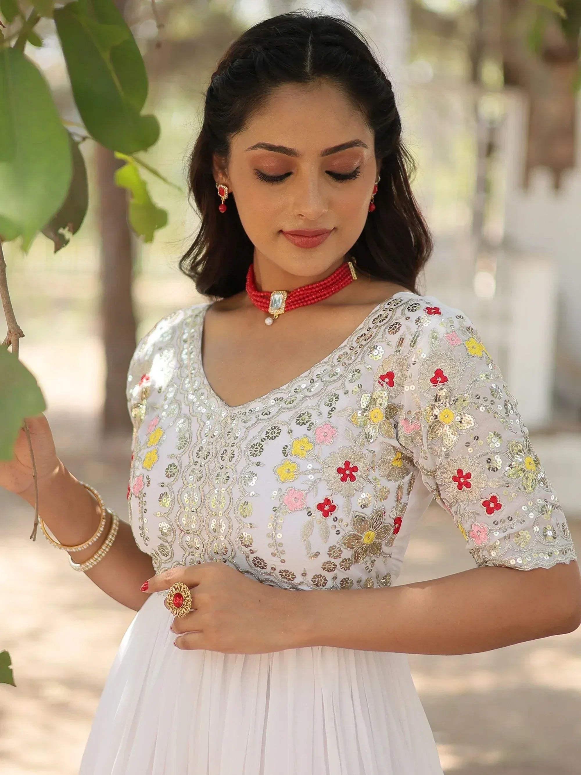 White floral embroidered ethnic gown with sequins, perfect for Indian occasions and festive wear.