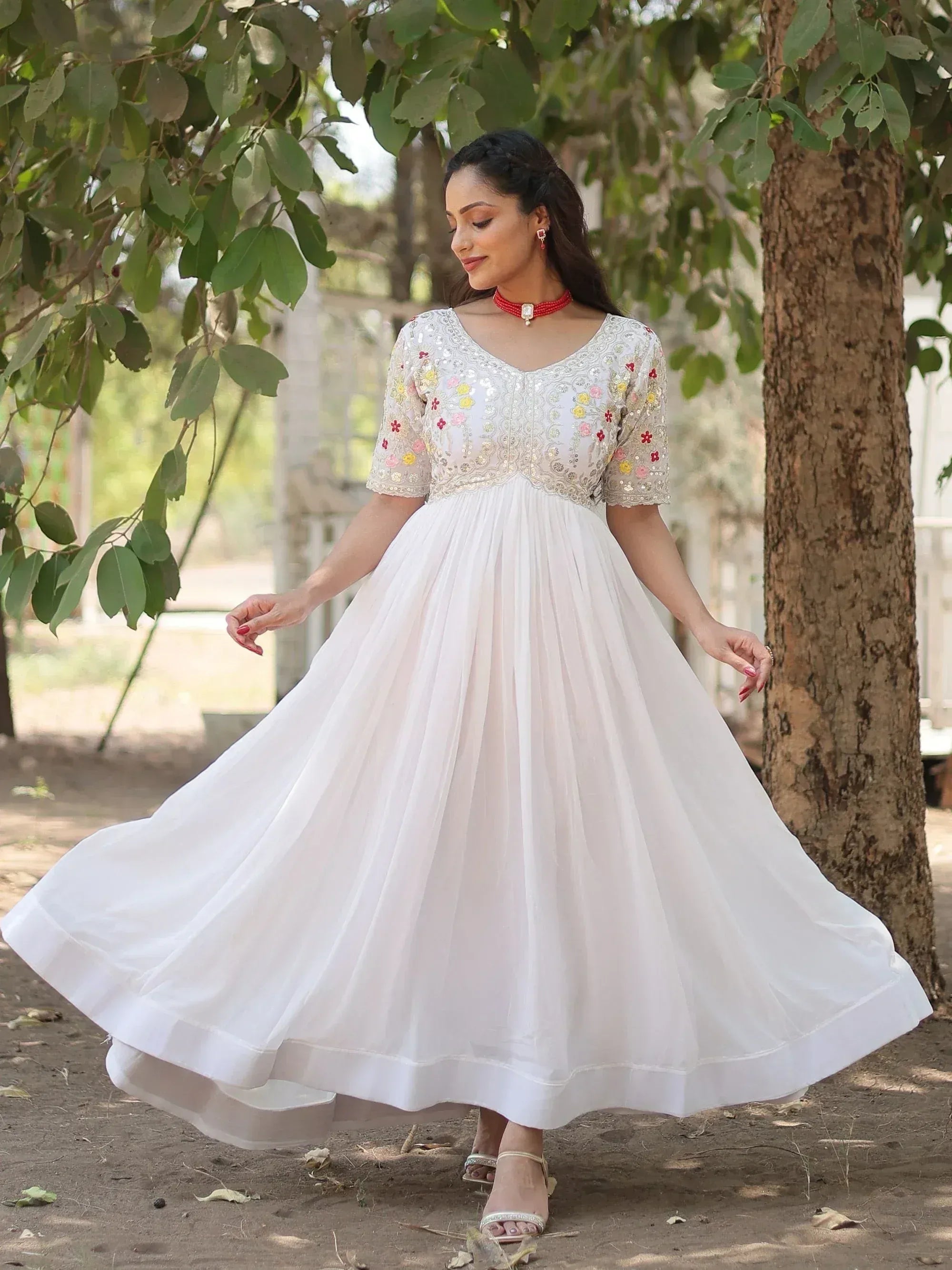 White floral embroidered ethnic gown with flared skirt, perfect for Indian occasions
