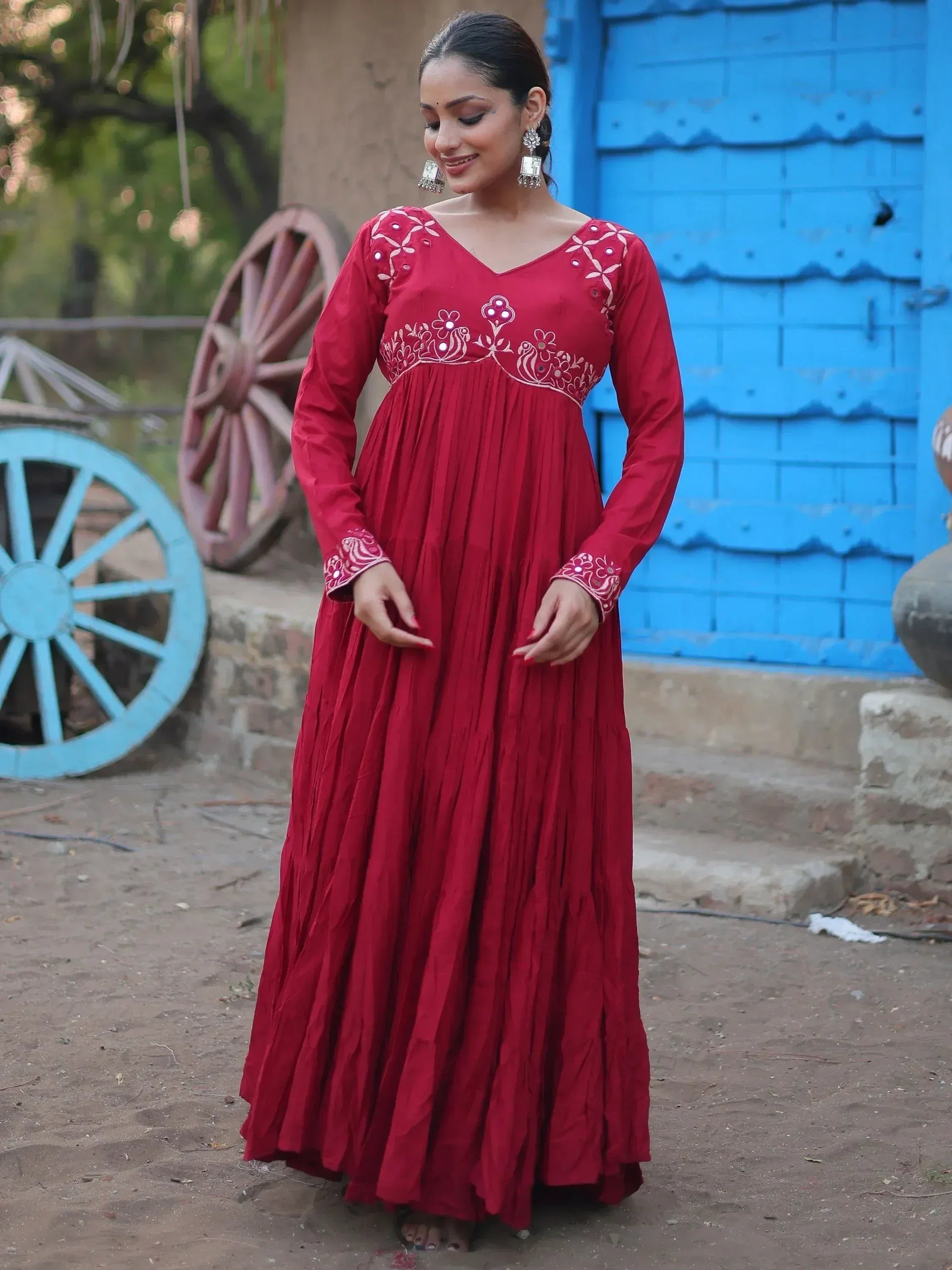 Red ethnic gown with floral embroidery, long sleeves, and pleated skirt for Indian wear