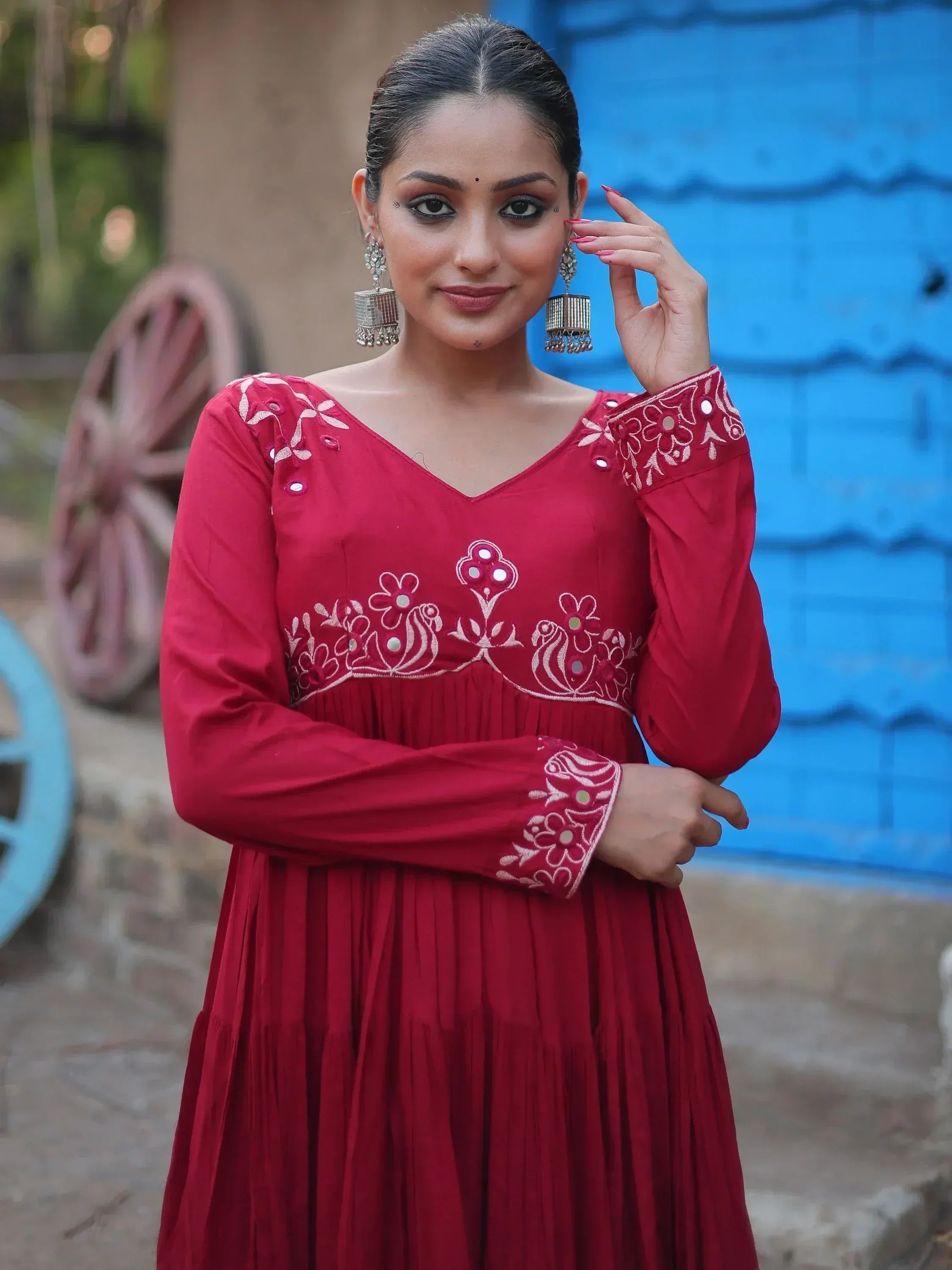 Red embroidered ethnic gown with mirror work, perfect for Indian occasions and festive wear.