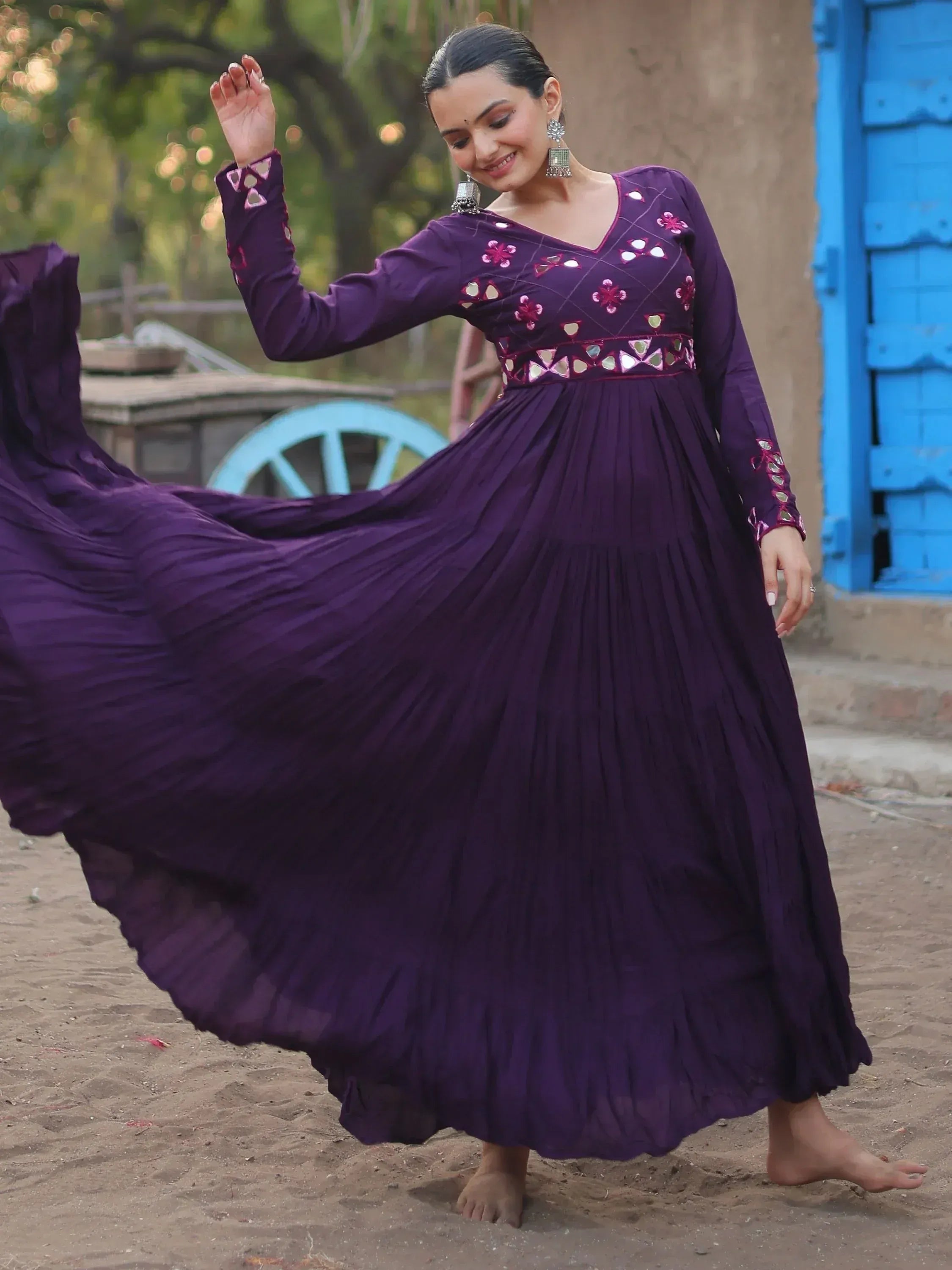 Purple ethnic gown with mirror work and floral embroidery, flowing pleated skirt, perfect for festive occasions