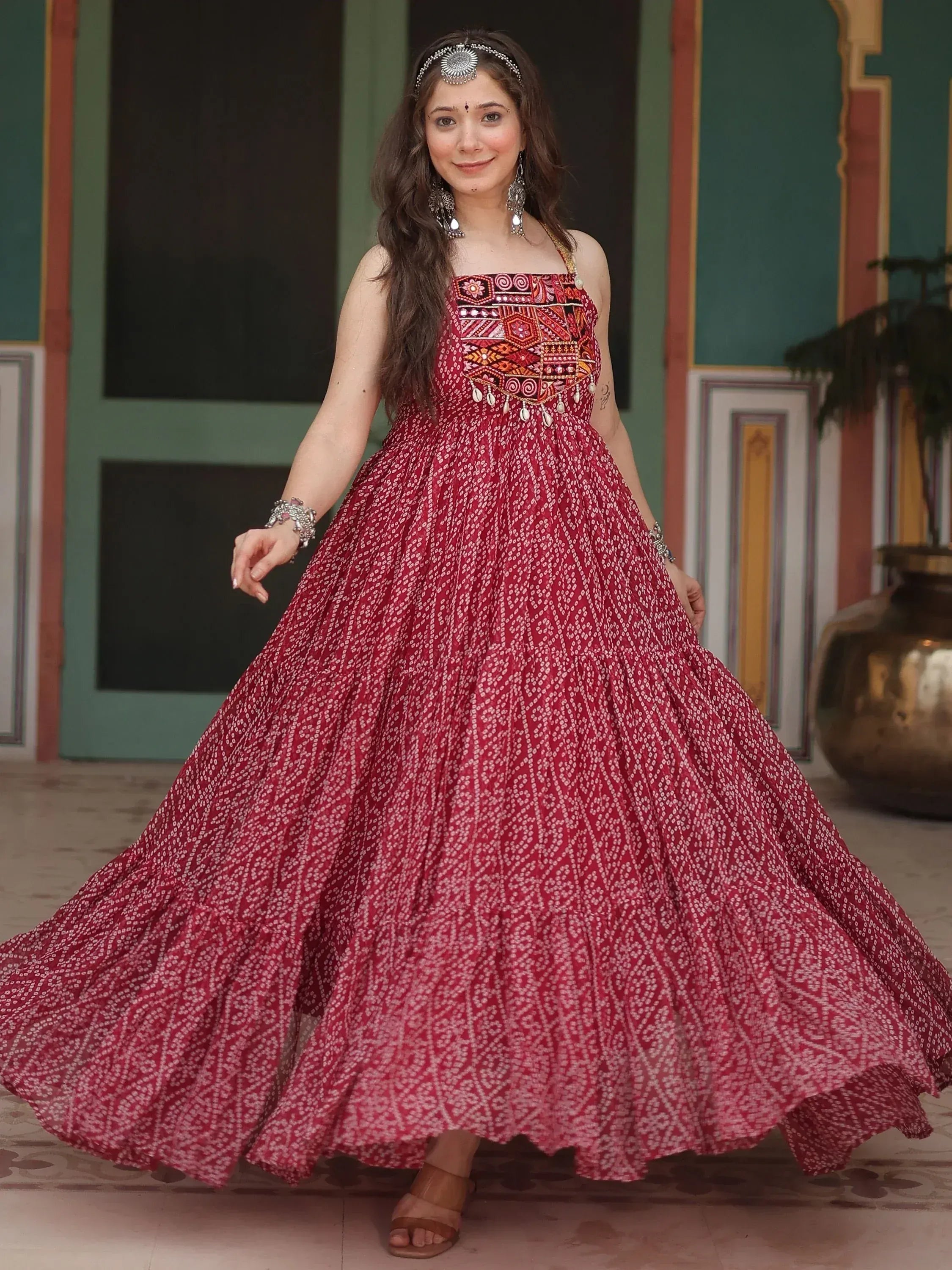 Woman in red ethnic gown with mirror work, perfect for Indian festive occasions and weddings