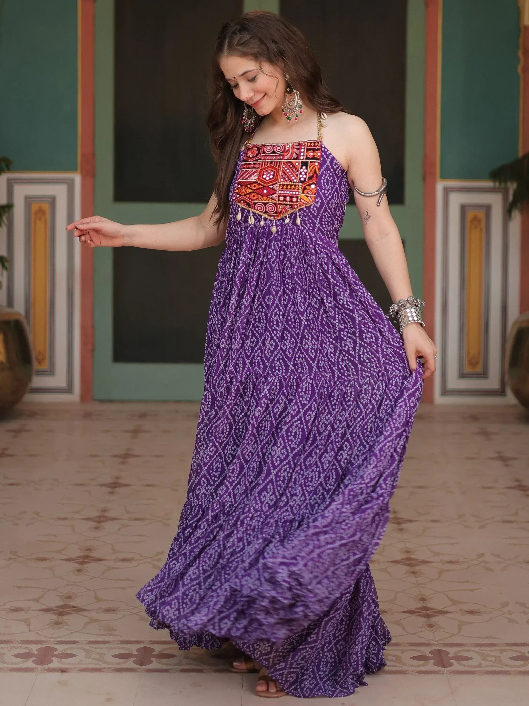 Purple ethnic gown with embroidered bodice and printed skirt, styled with traditional jewelry