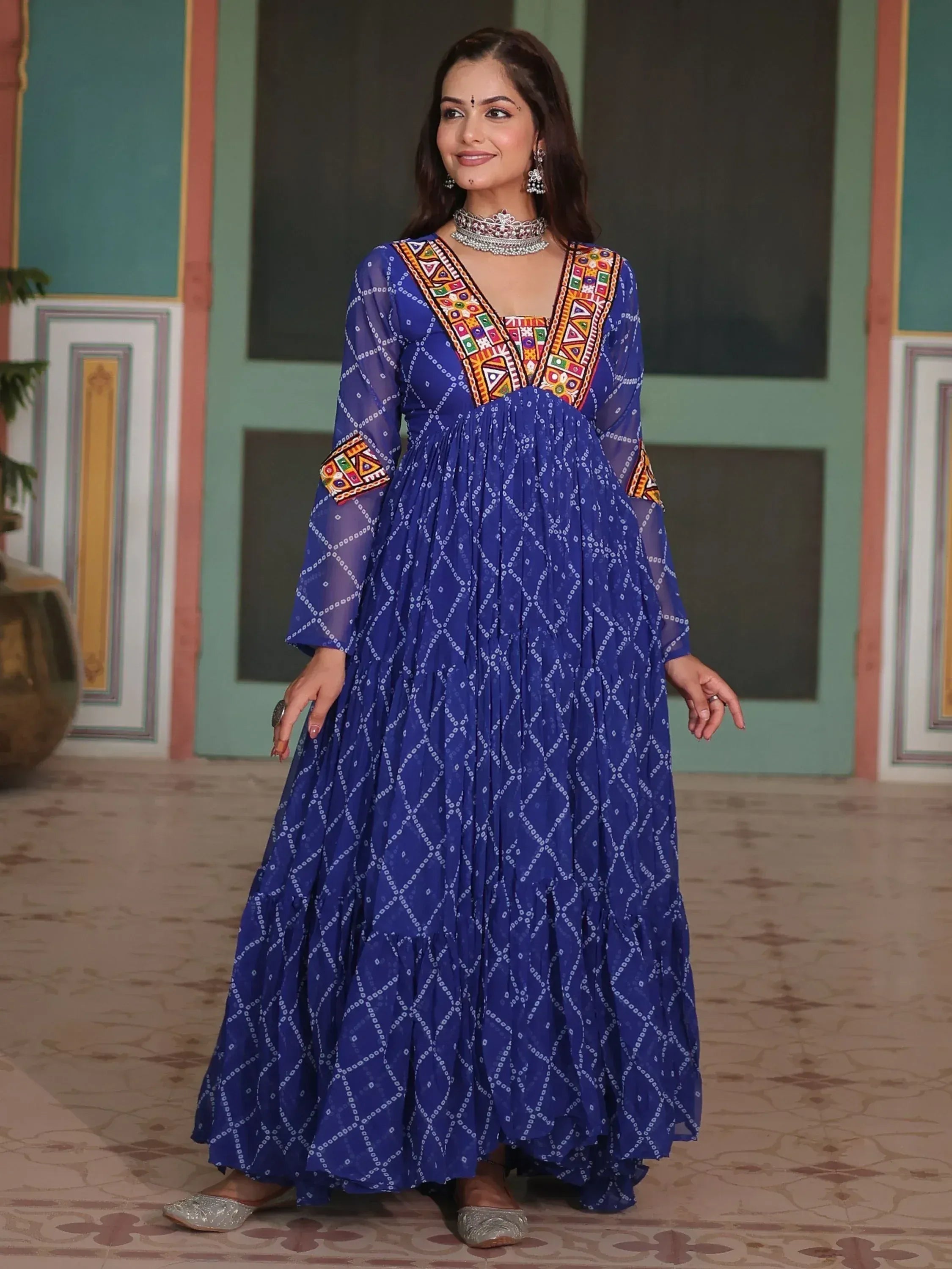 Blue ethnic gown with colorful embroidery and bandhani print, perfect for Indian festive occasions