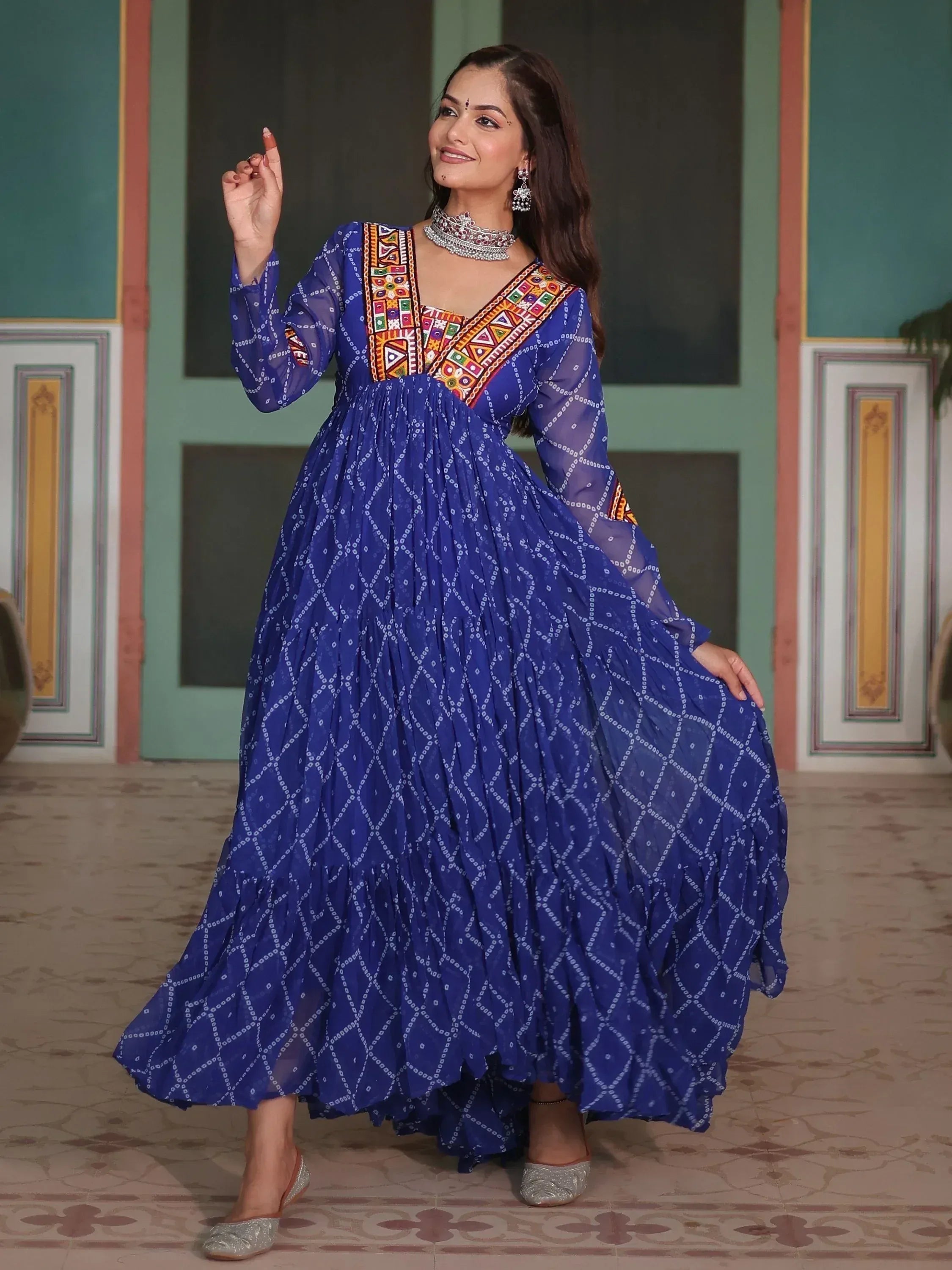 Blue ethnic gown with colorful embroidery and sheer sleeves, perfect for Indian festive wear