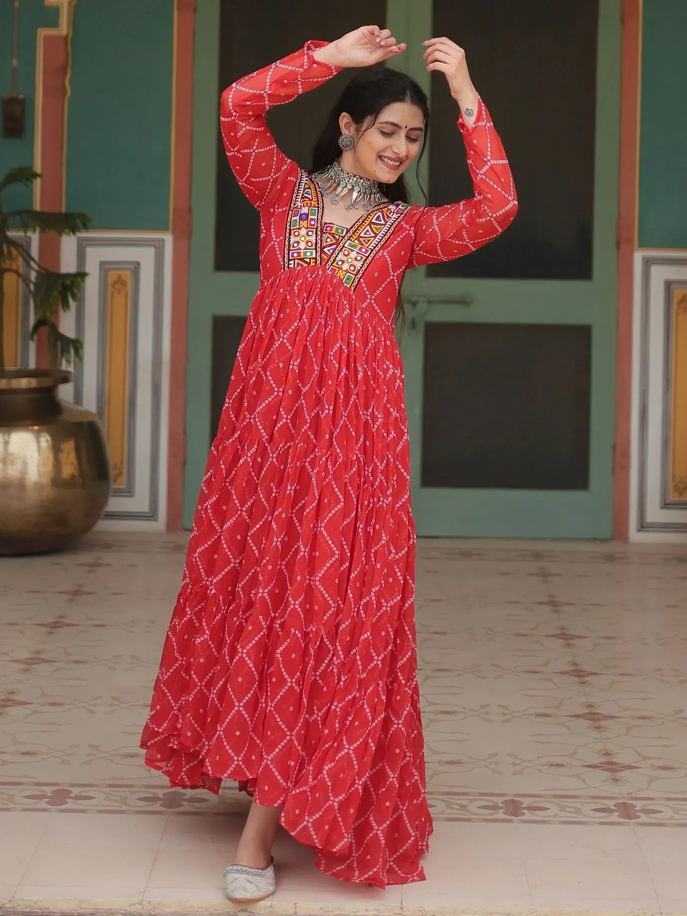 Red ethnic gown with bandhani print and mirror work, perfect for Indian festivals and occasions.