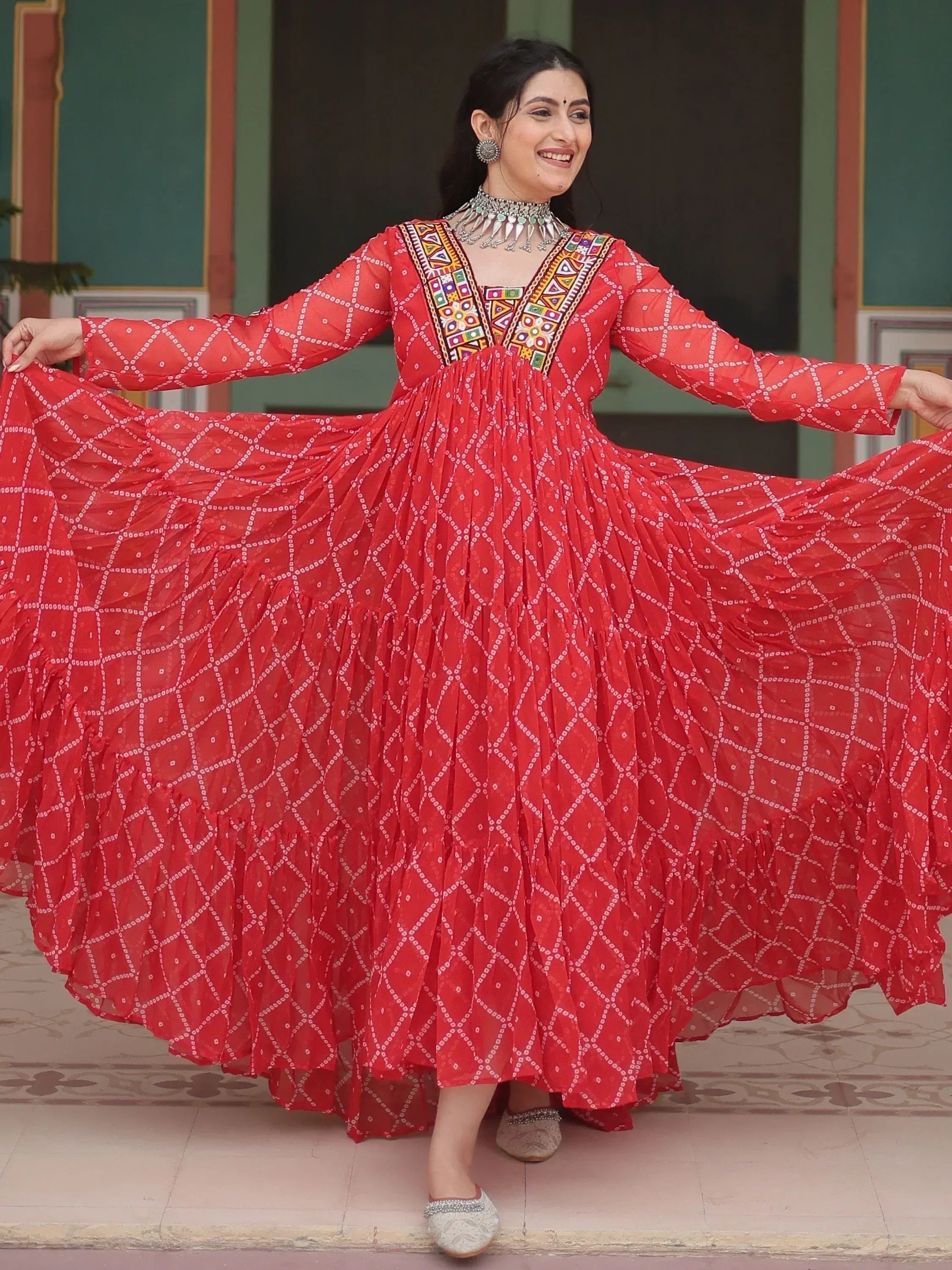 Red ethnic gown with mirror work and geometric print, perfect for Indian festive occasions