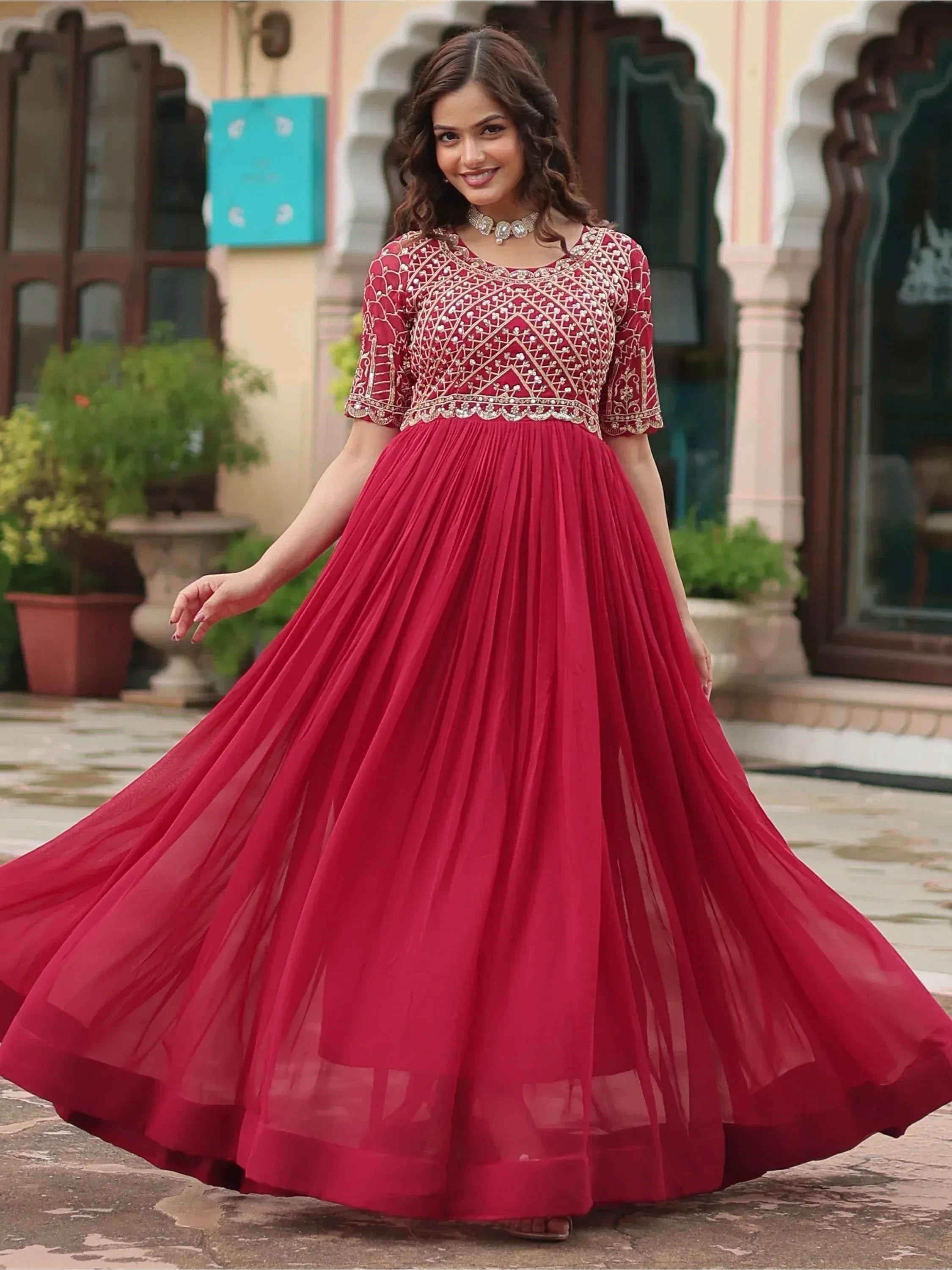 Red embroidered ethnic gown with flared skirt, perfect for Indian celebrations and weddings
