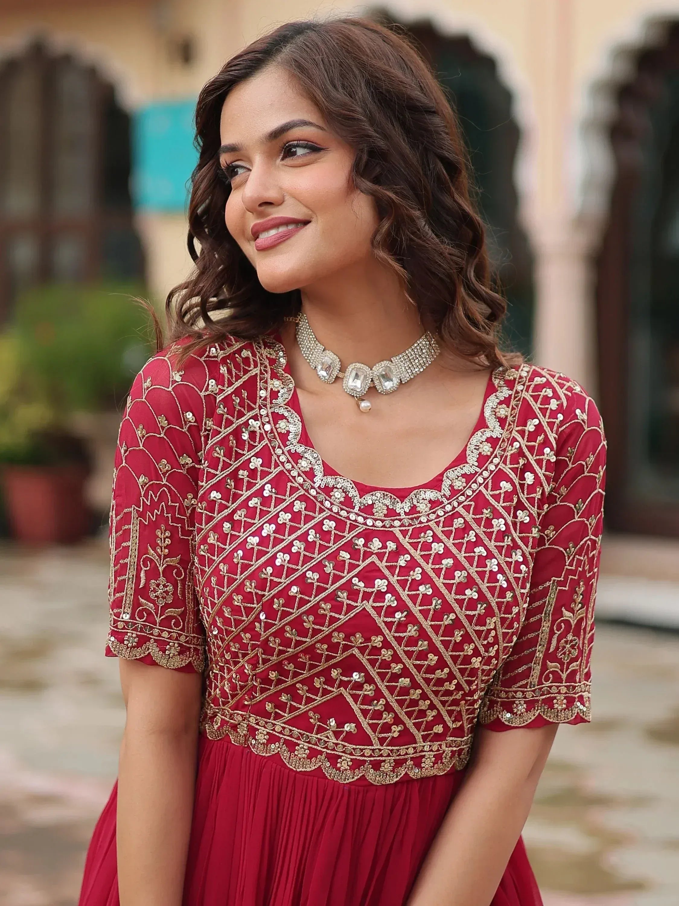 Red ethnic gown with gold embroidery and sequins, perfect for Indian weddings or festive occasions