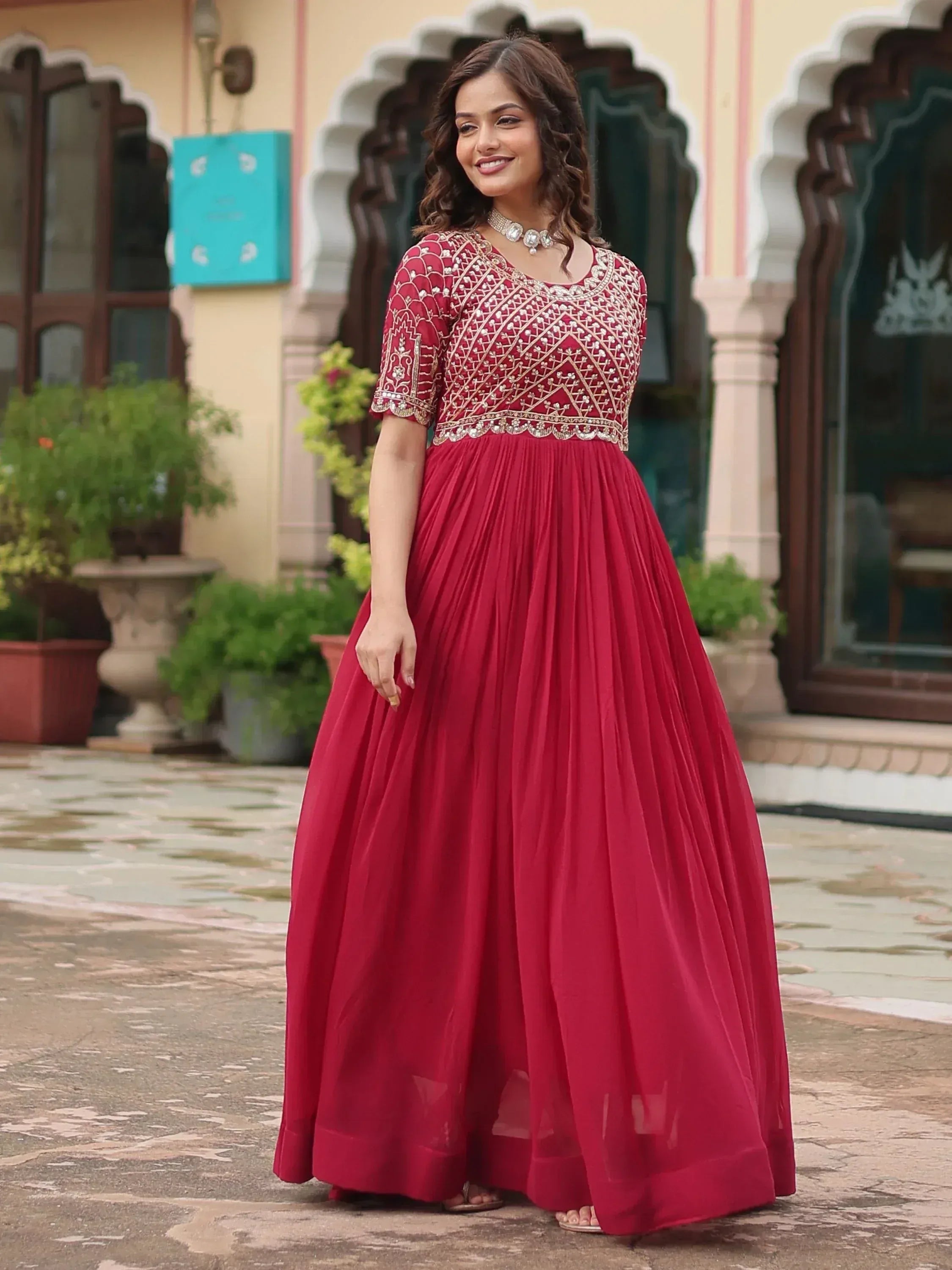 Red ethnic gown with gold embroidery, perfect for Indian weddings and festive occasions