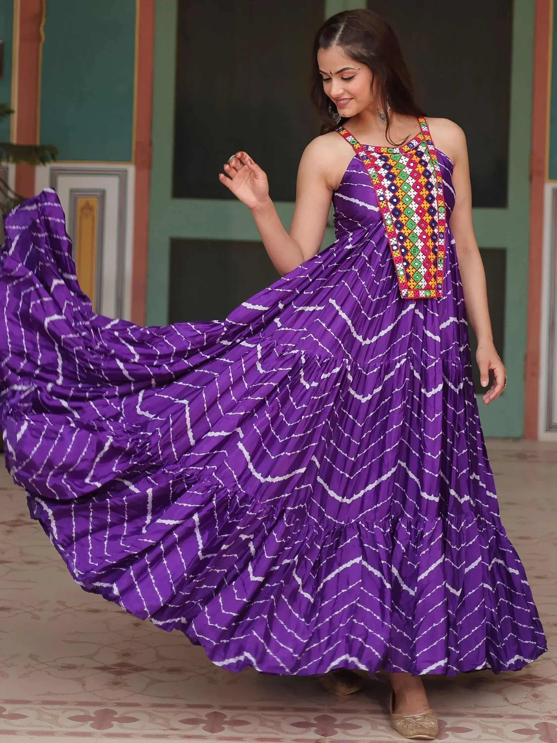 Purple ethnic gown with mirror work and white zigzag print, perfect for Indian festive occasions