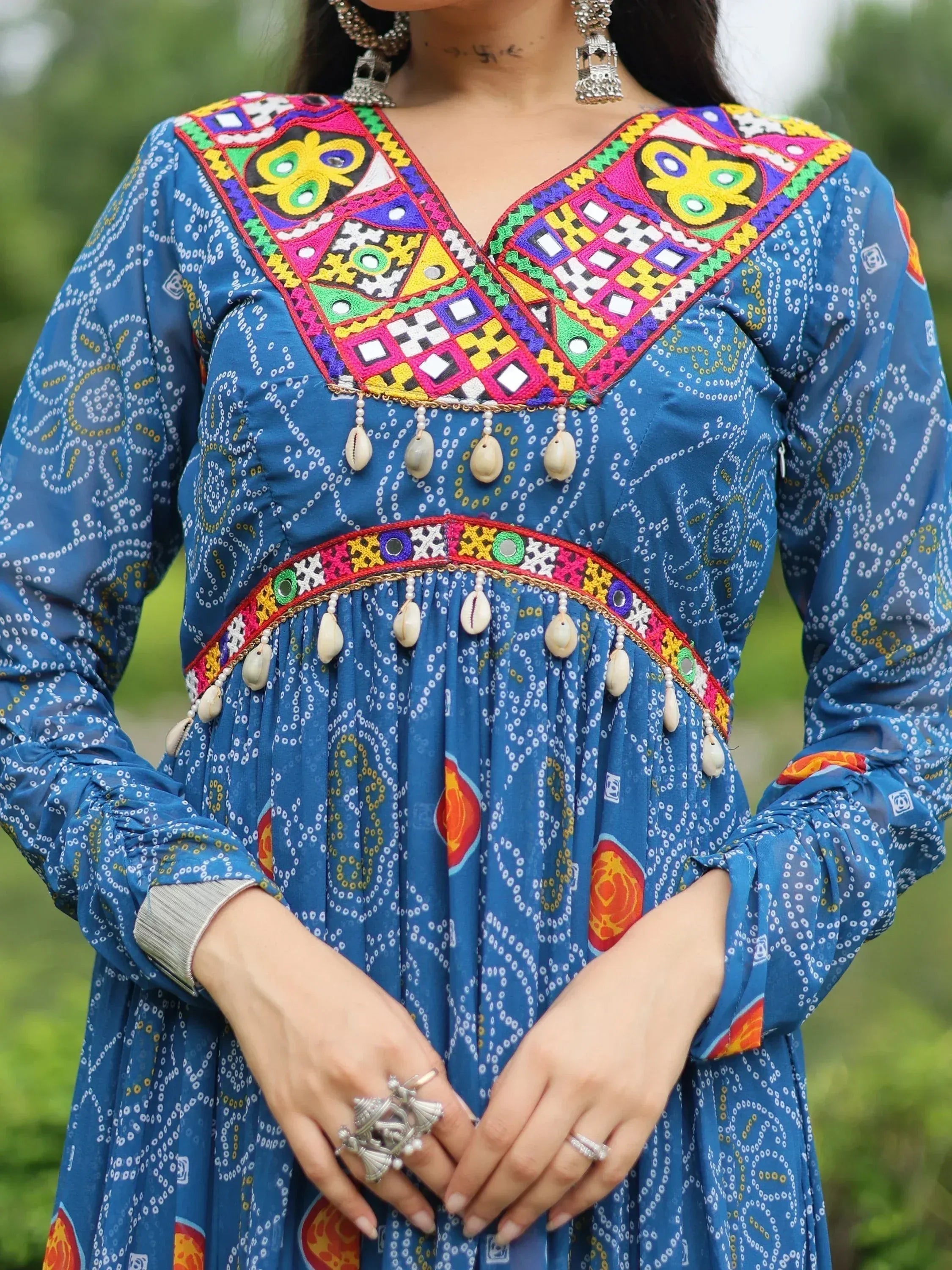 Blue ethnic kurta with vibrant mirror work, shell embellishments, and colorful geometric embroidery for festive occasions
