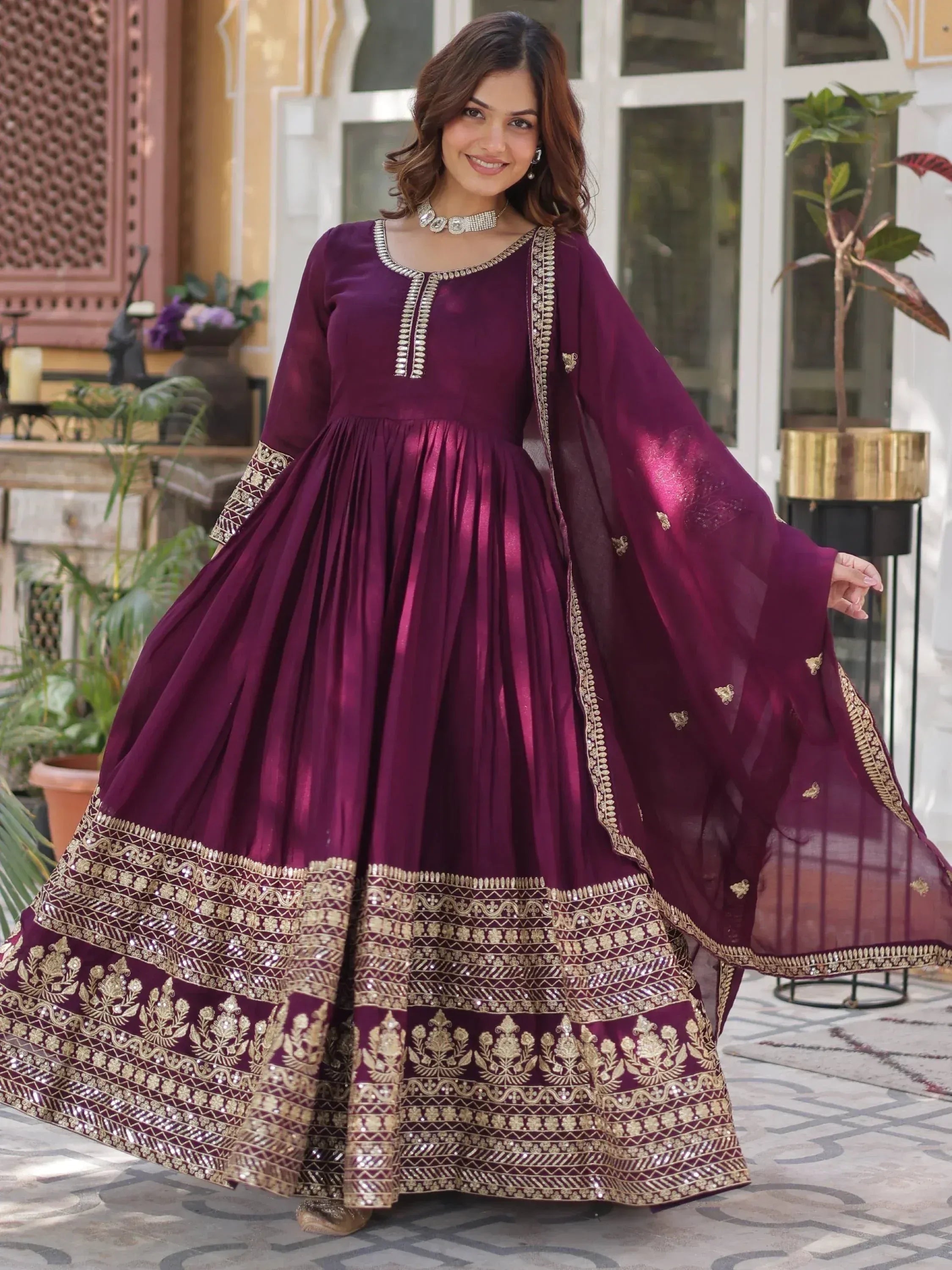 Elegant maroon anarkali suit with gold embroidery and dupatta, perfect for Indian ethnic occasions.