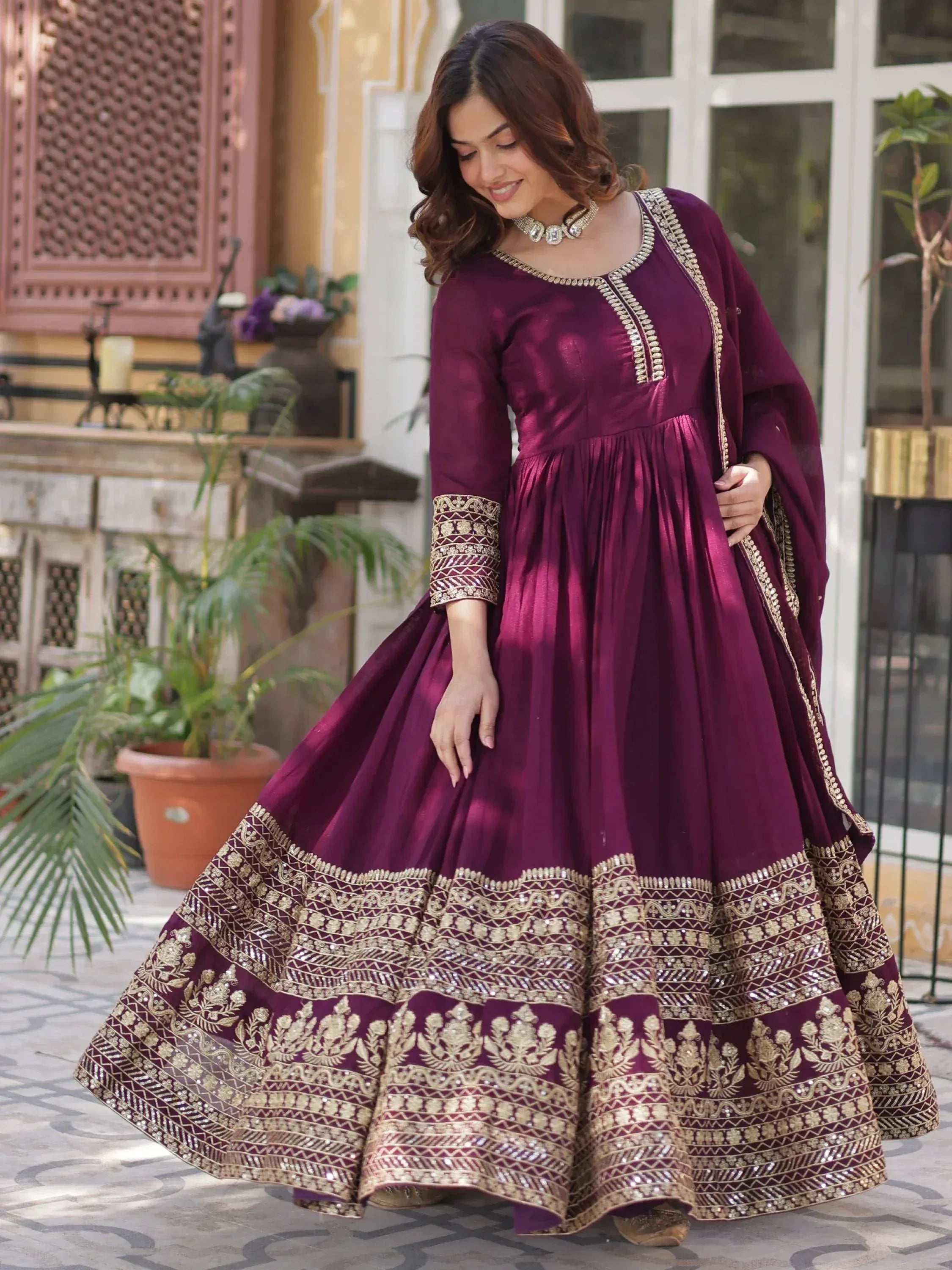 Elegant maroon anarkali with gold embroidery, perfect for Indian ethnic wear occasions.