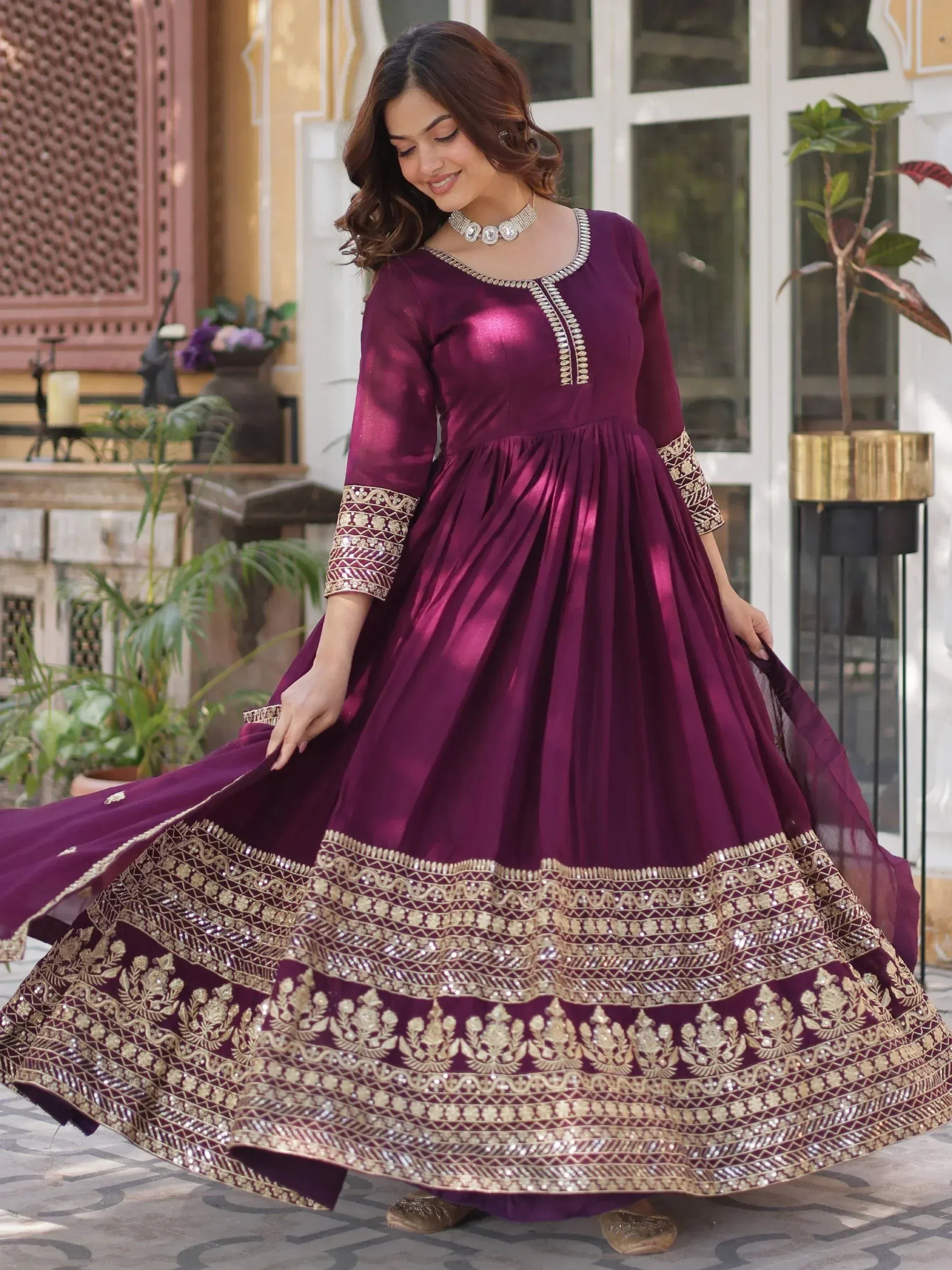 Elegant maroon ethnic gown with gold embroidery, perfect for festive occasions and Indian celebrations.