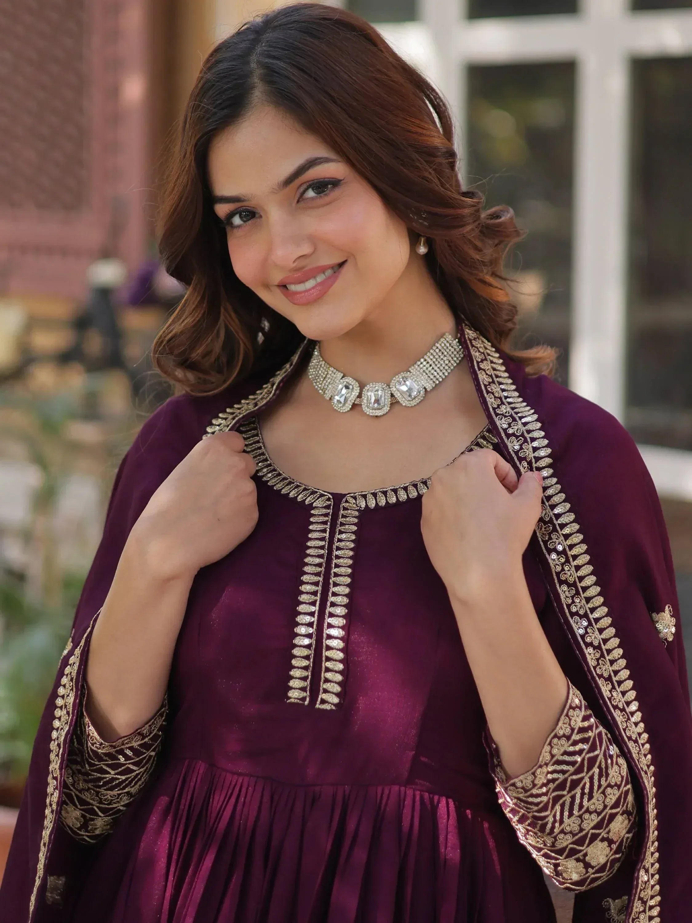 Elegant maroon ethnic gown with gold embroidery, perfect for Indian festivities and weddings.