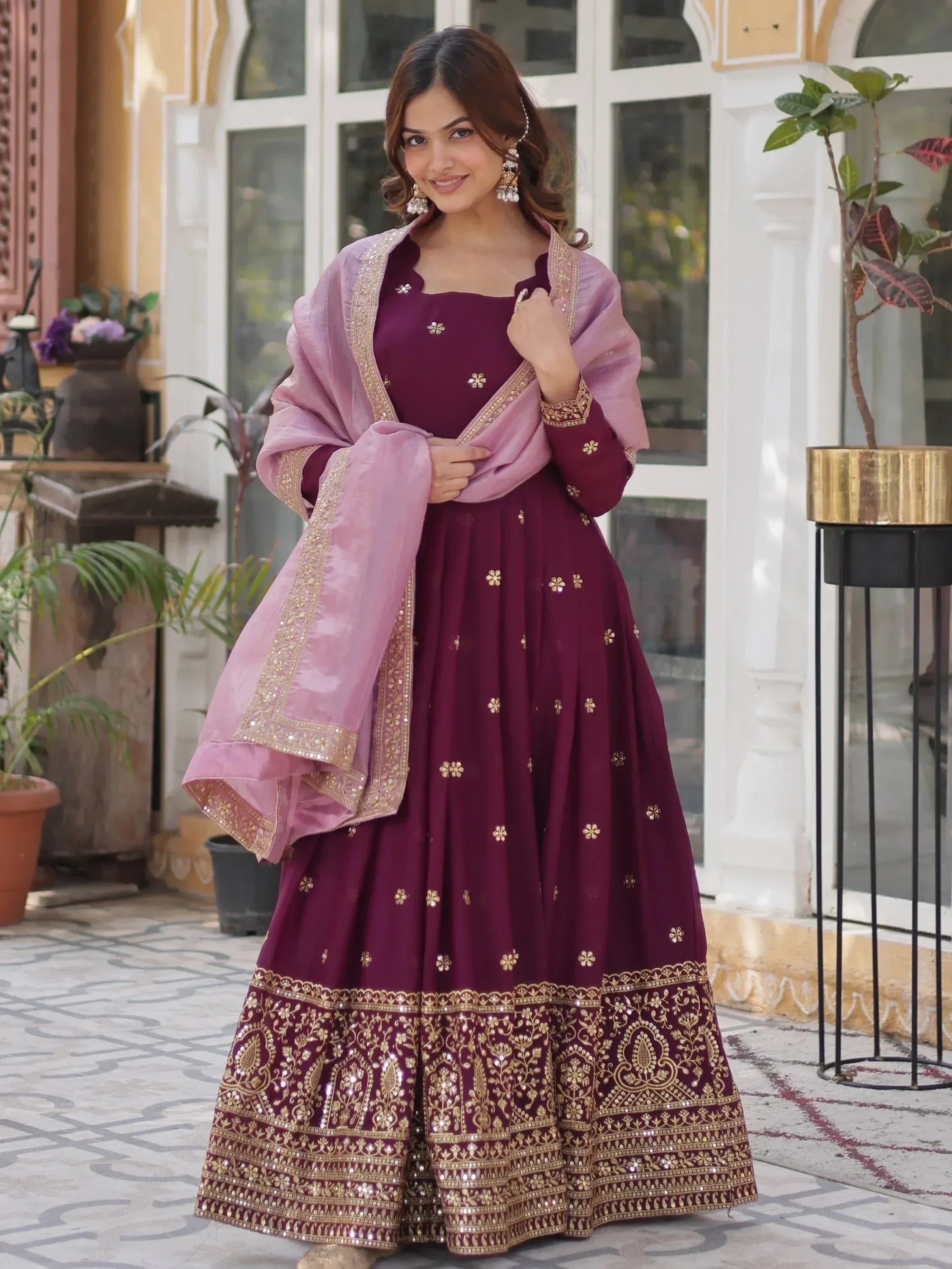Maroon embroidered anarkali with gold detailing and pink dupatta, perfect for Indian ethnic occasions.