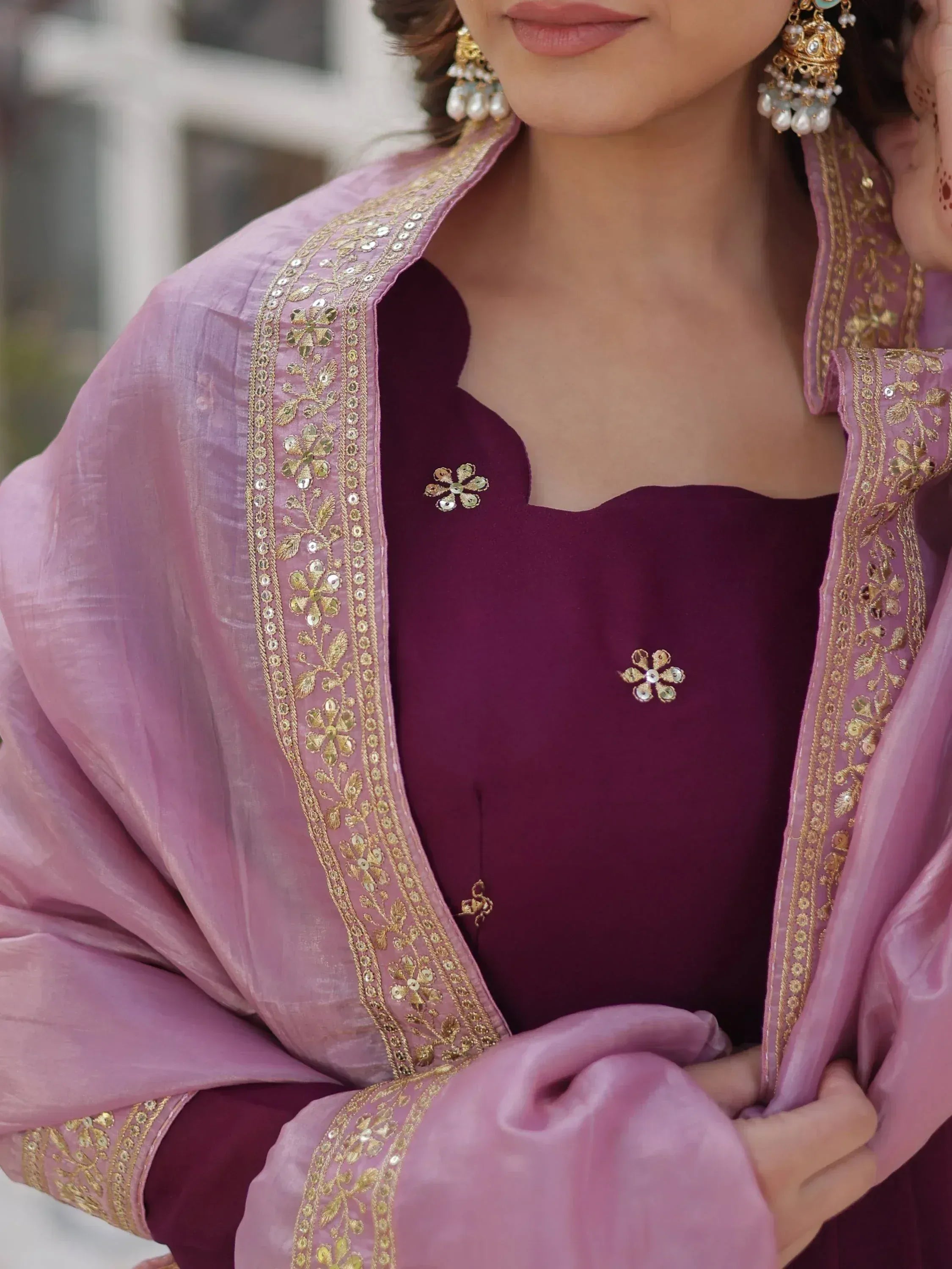 Elegant Indian ethnic wear with gold embroidery, purple blouse, and pink dupatta, perfect for festive occasions.