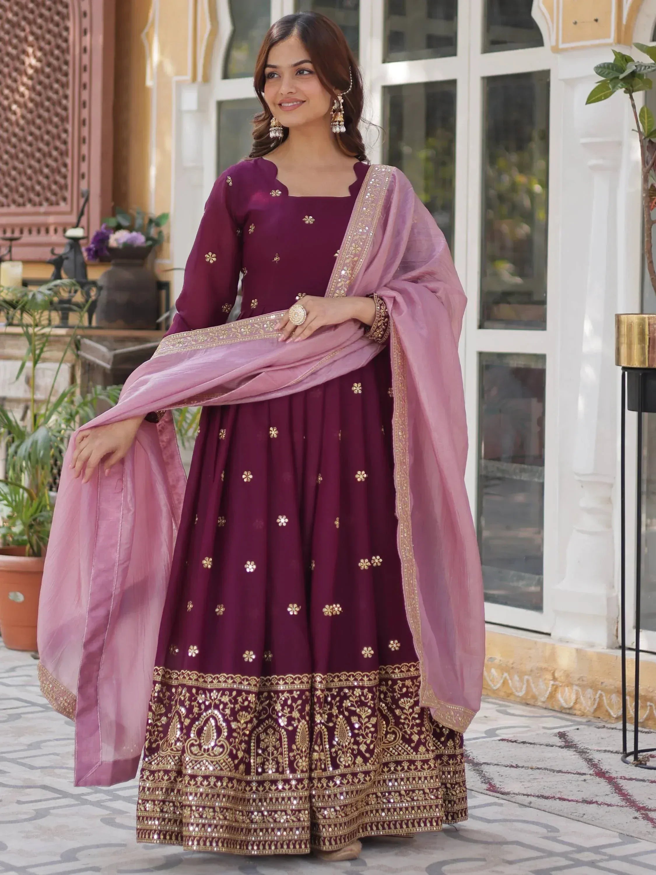 Elegant maroon anarkali with gold embroidery and pink dupatta, perfect for Indian ethnic occasions