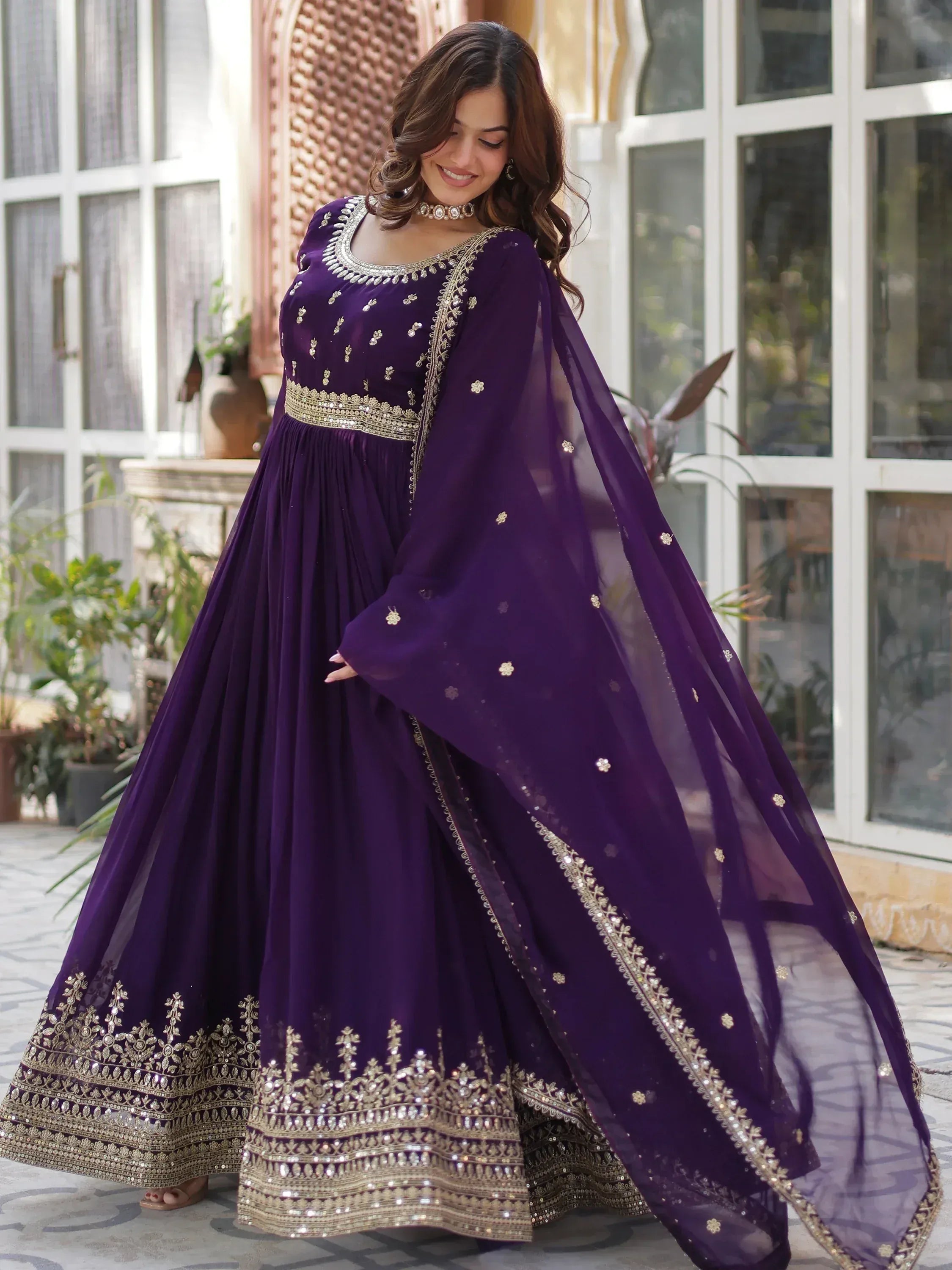 Purple ethnic gown with gold embroidery and sheer dupatta for festive occasions