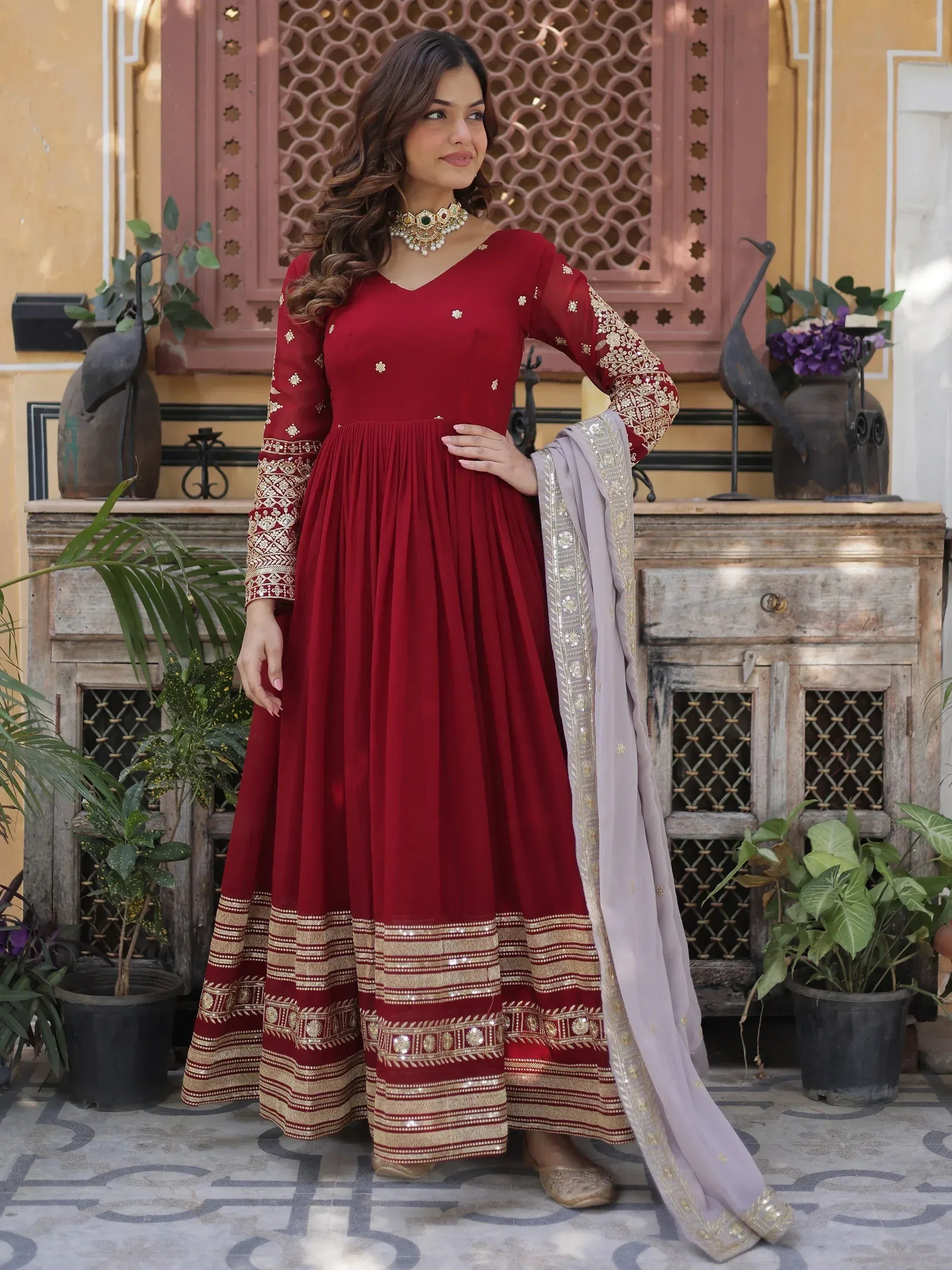 Woman in maroon embroidered Anarkali gown with dupatta, Indian ethnic wear fashion