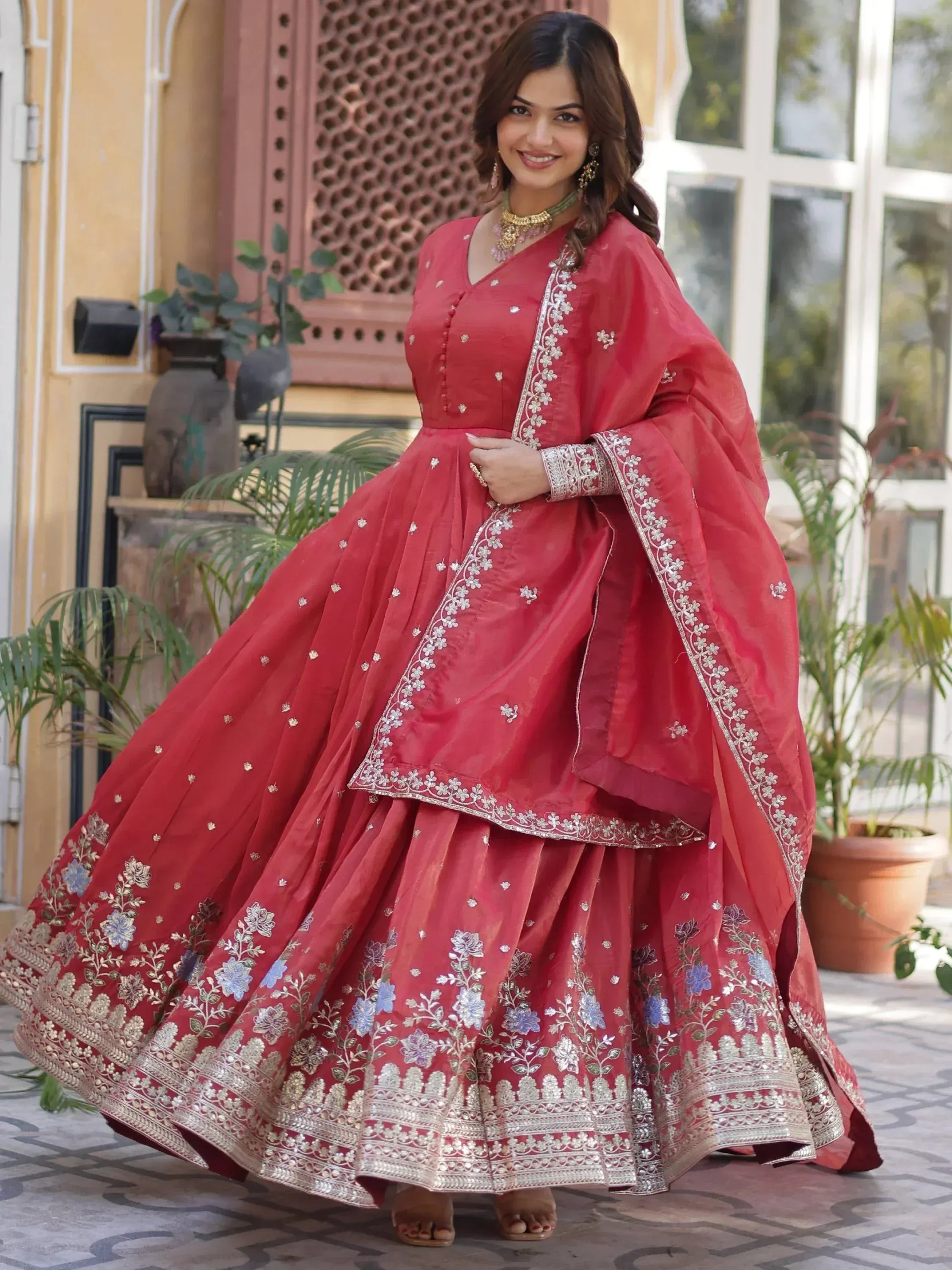 Red embroidered lehenga choli with floral motifs and silver detailing, perfect for Indian ethnic wear occasions