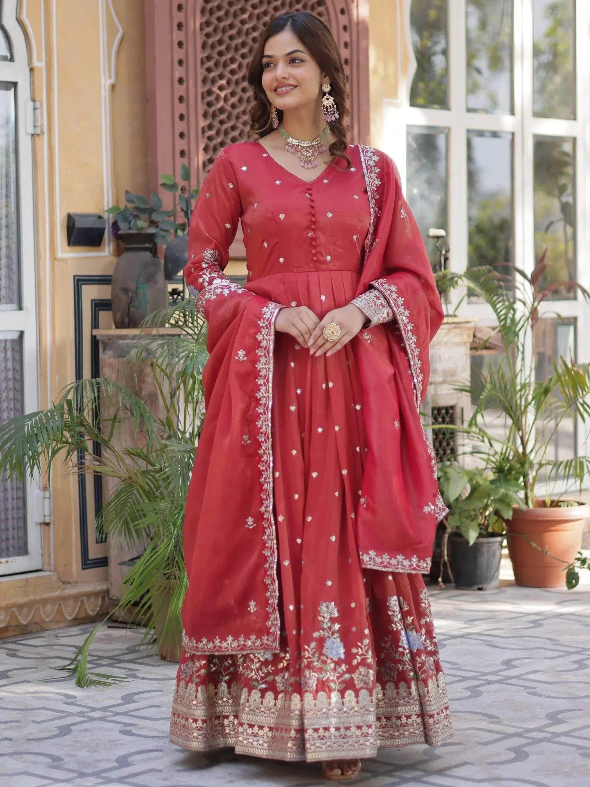 Red embroidered Indian anarkali suit with floral detailing, perfect for festive occasions and weddings.