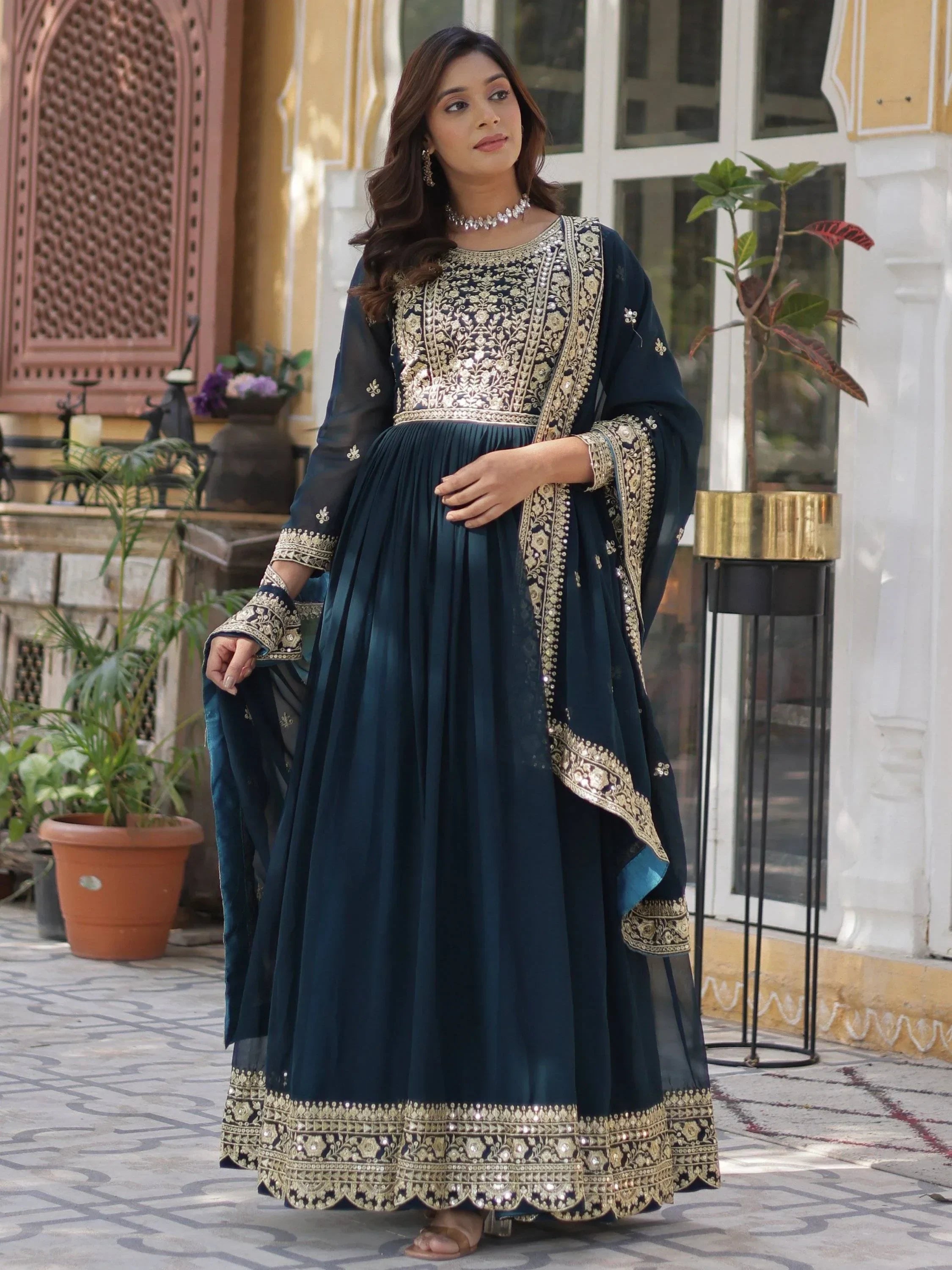 Woman wearing navy blue embroidered designer Anarkali gown with dupatta, ethnic Indian wear