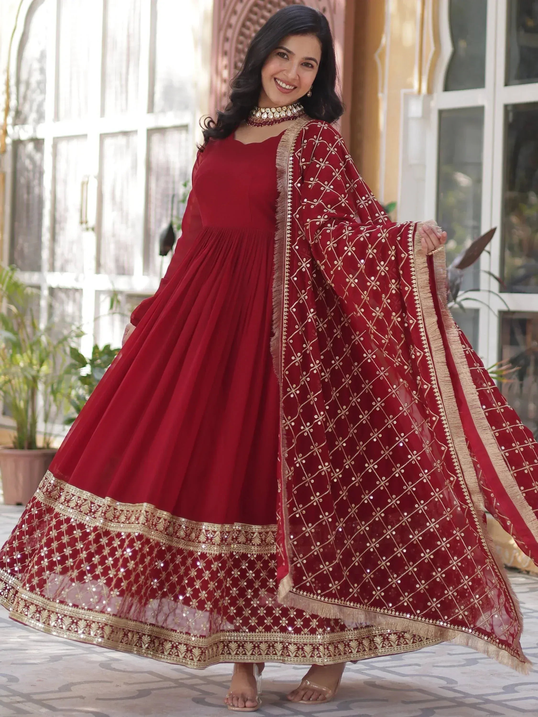 Red ethnic gown with gold embroidery and dupatta, perfect for Indian weddings and festive occasions