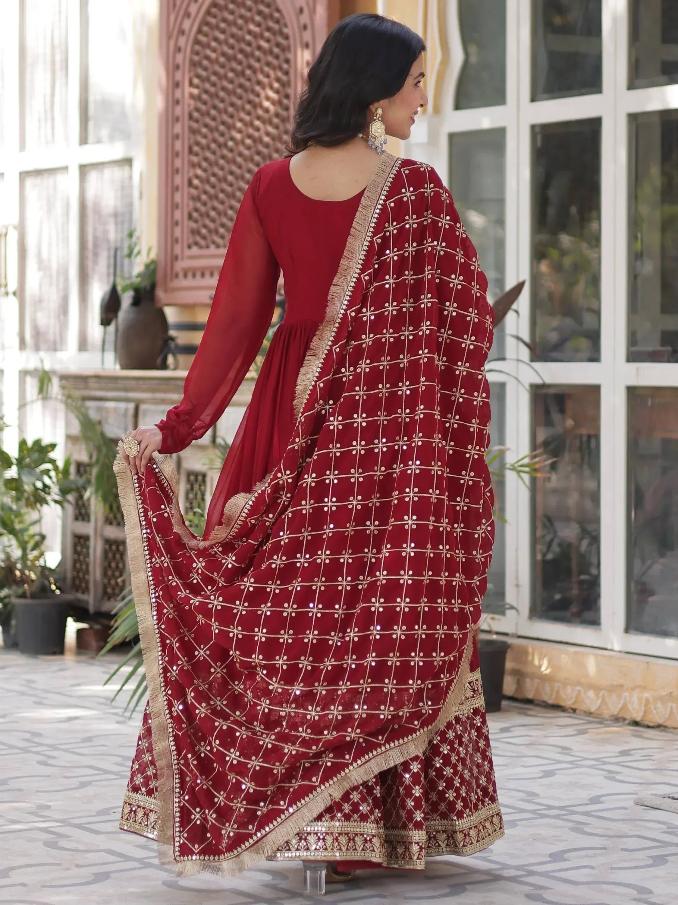 Red embroidered Indian anarkali suit with gold mirror work and dupatta, perfect for festive occasions